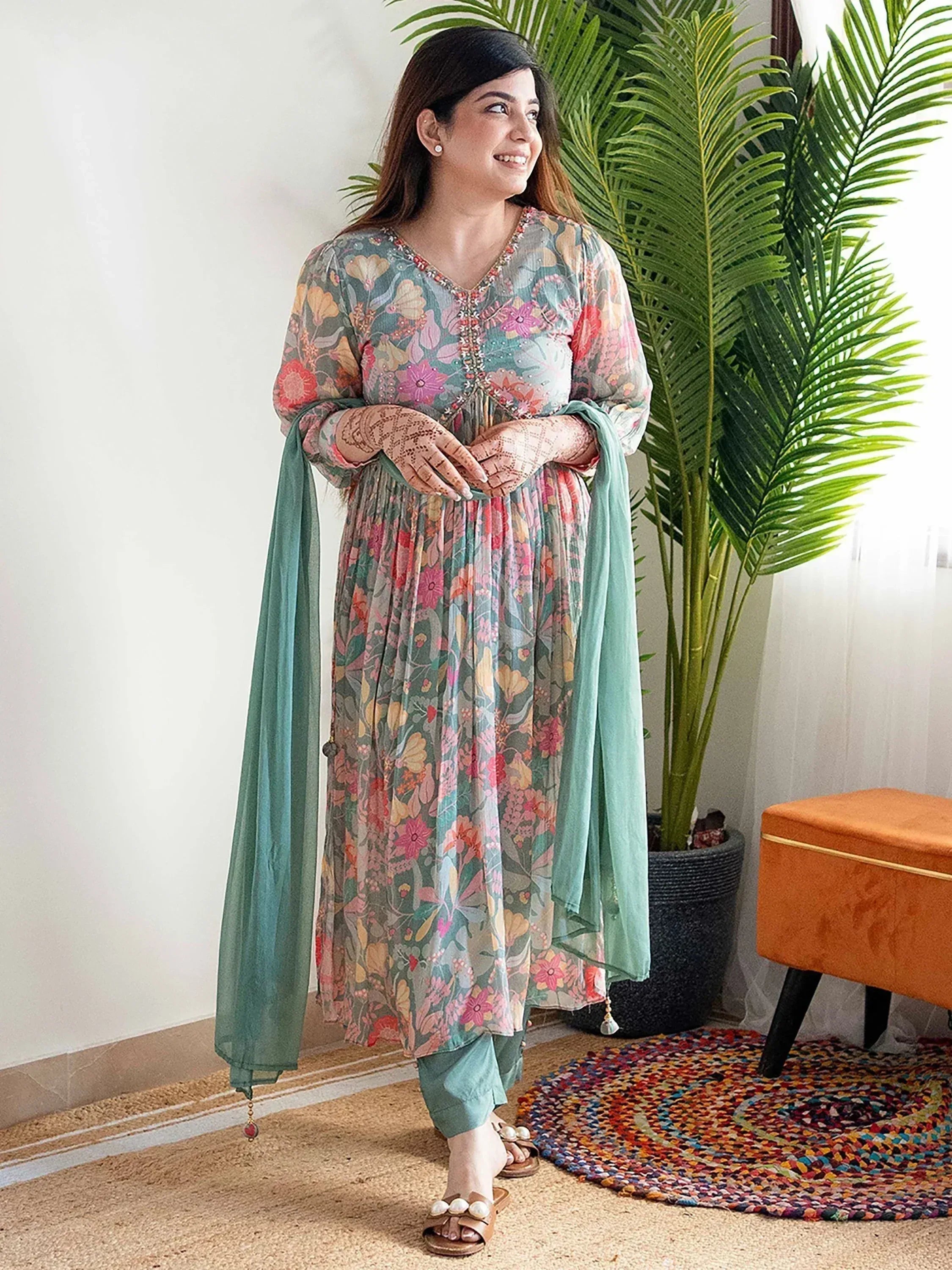 Floral print ethnic kurti with embroidered neckline, paired with mint pants and dupatta, perfect for festive occasions.