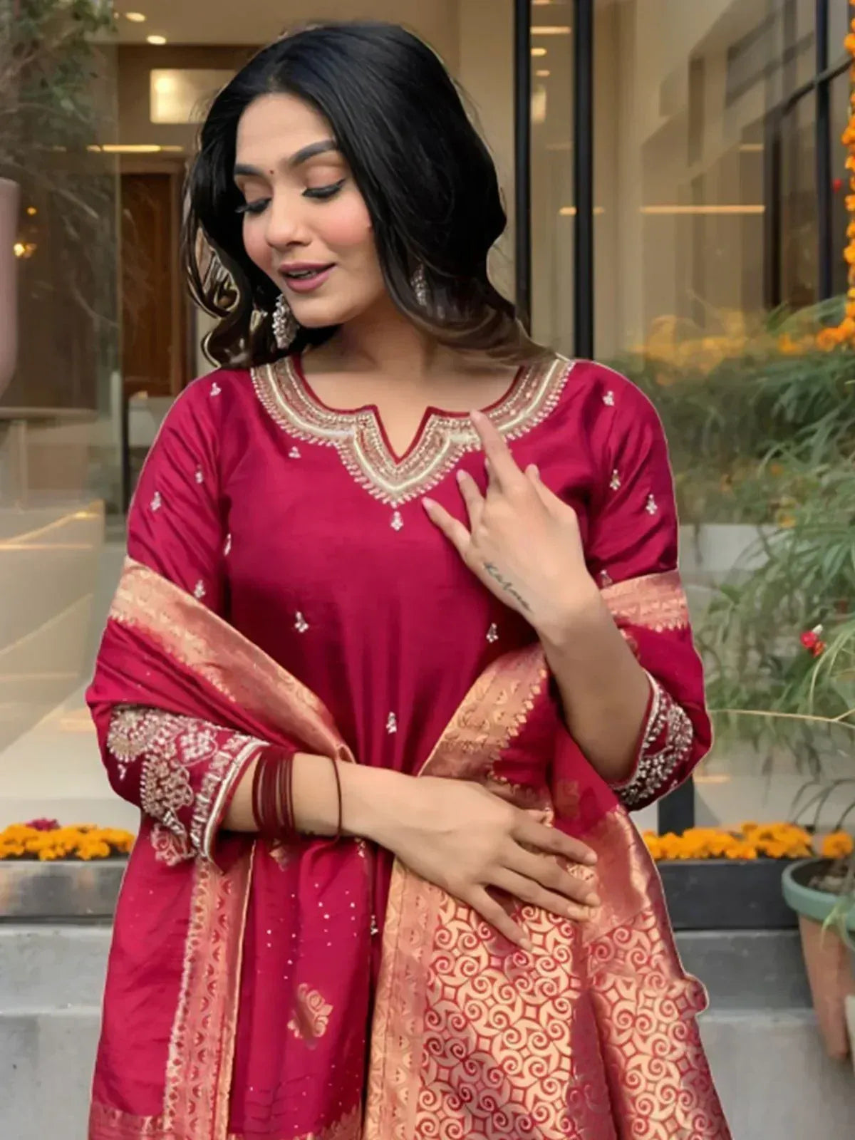 Woman in maroon ethnic salwar kameez with gold embroidery and dupatta, perfect for festive occasions