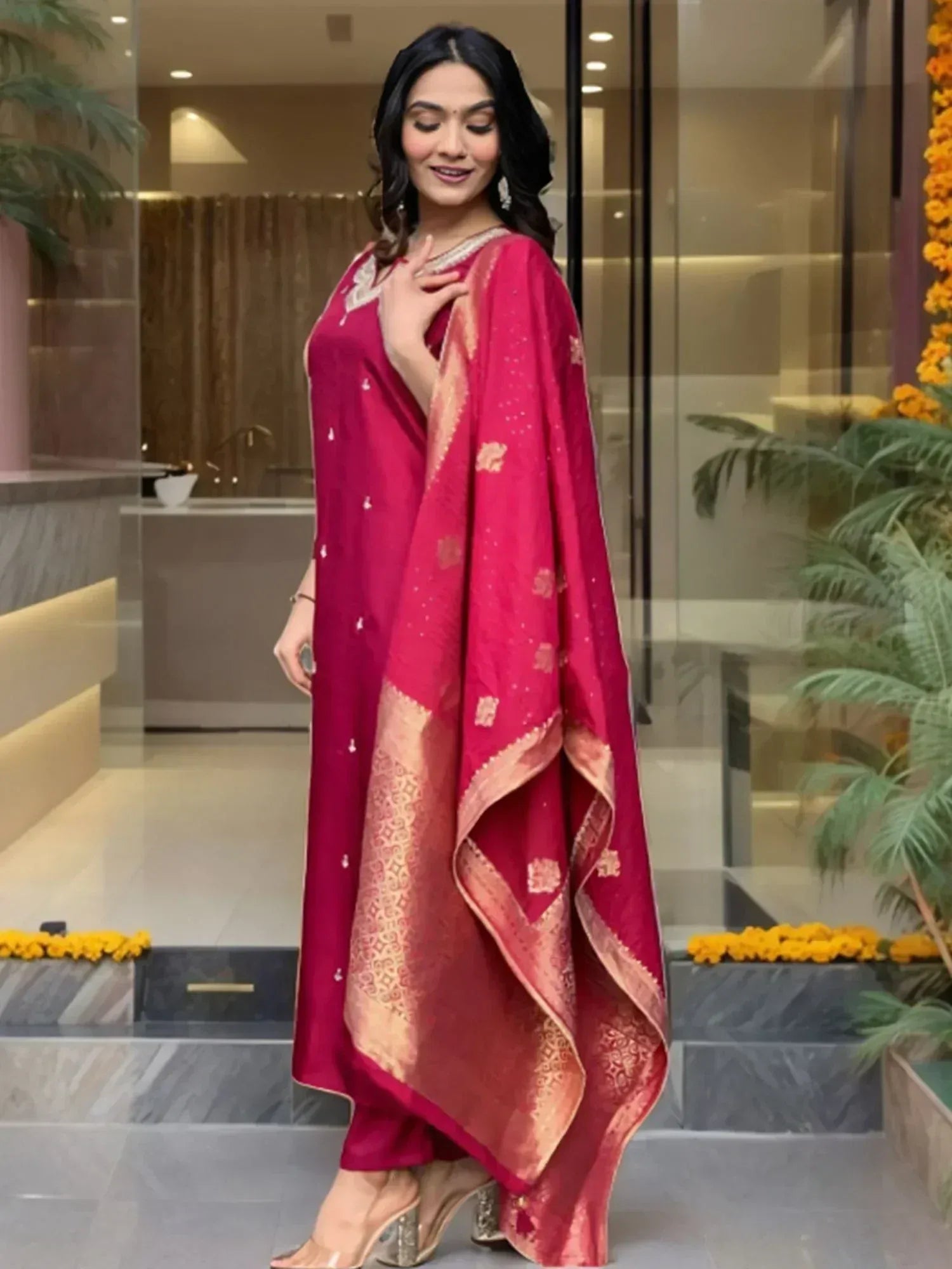 Woman in elegant maroon salwar kameez with gold embroidery and dupatta, perfect for Indian ethnic occasions