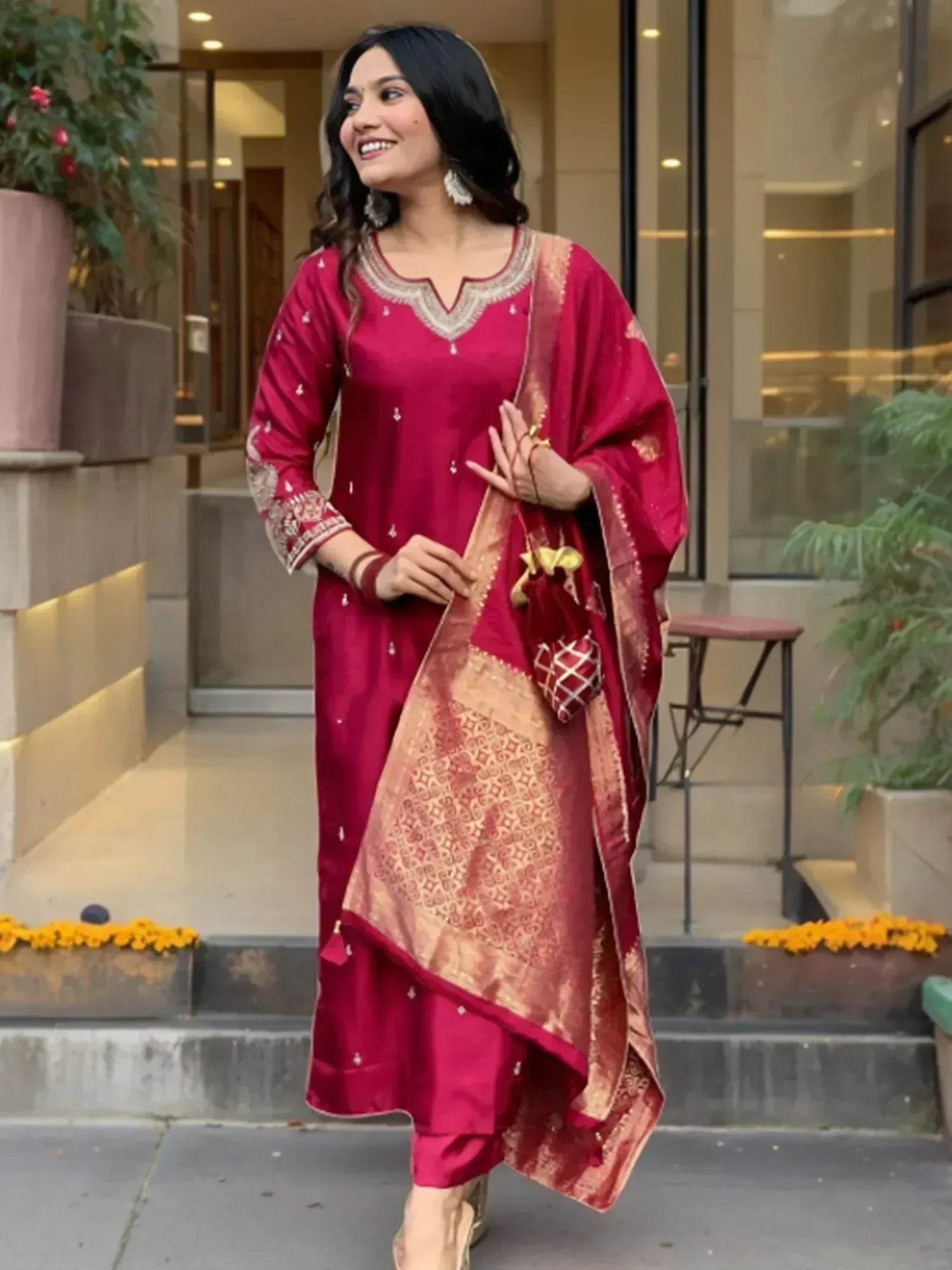 Woman in maroon embroidered salwar kameez with gold dupatta, perfect for Indian ethnic wear occasions