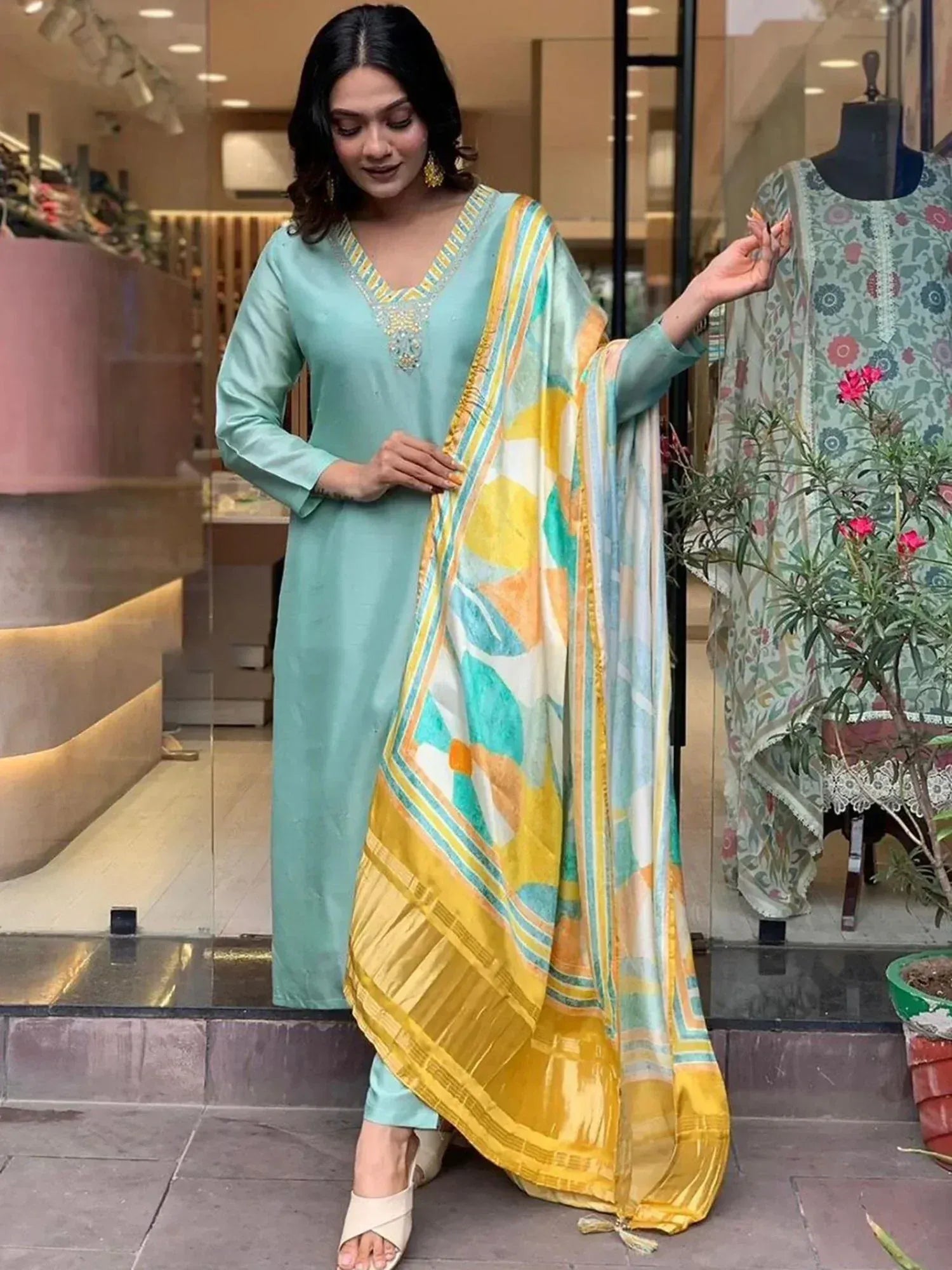 Woman in mint green salwar kameez with yellow floral dupatta, ethnic Indian wear