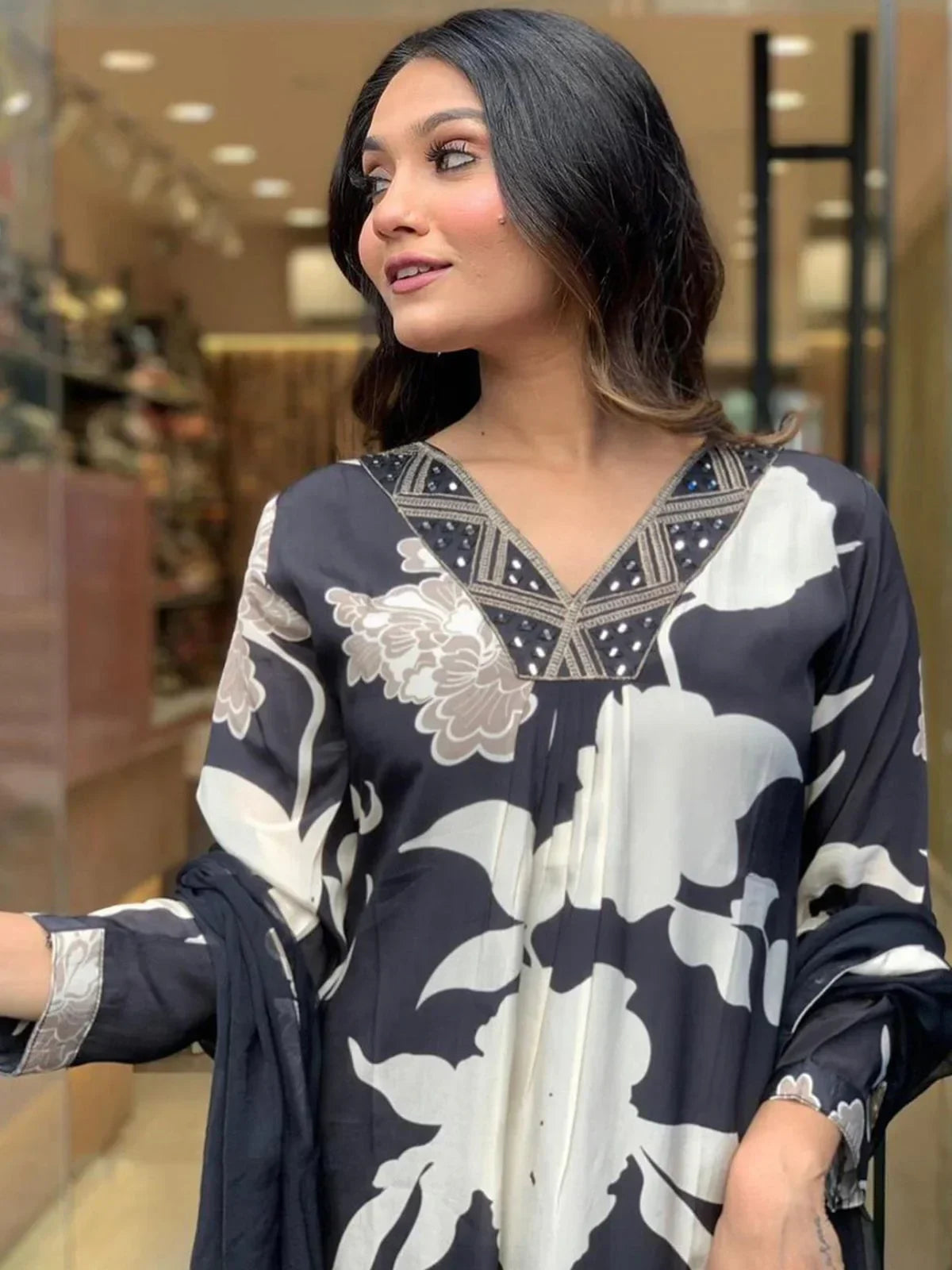 Woman wearing black and white floral print ethnic kurta with embellished neckline
