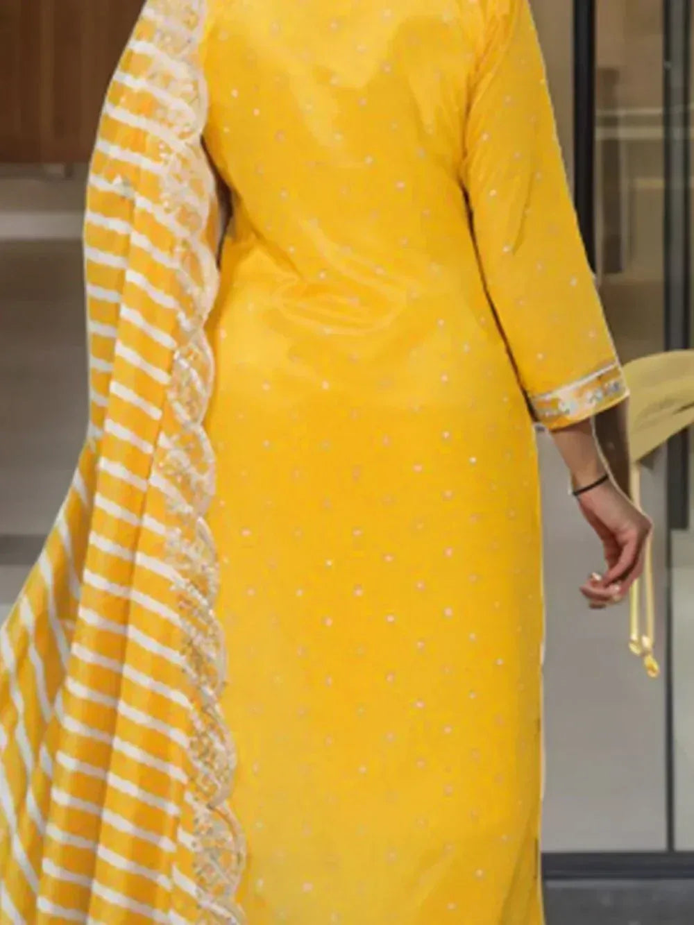 Yellow ethnic salwar kameez with white polka dots and striped dupatta, perfect for festive occasions