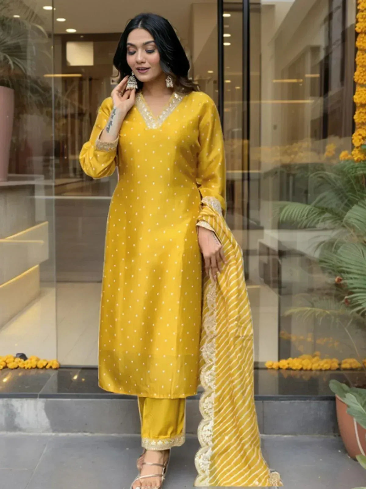 Yellow polka dot salwar kameez with embroidered neckline and striped dupatta, perfect for ethnic occasions