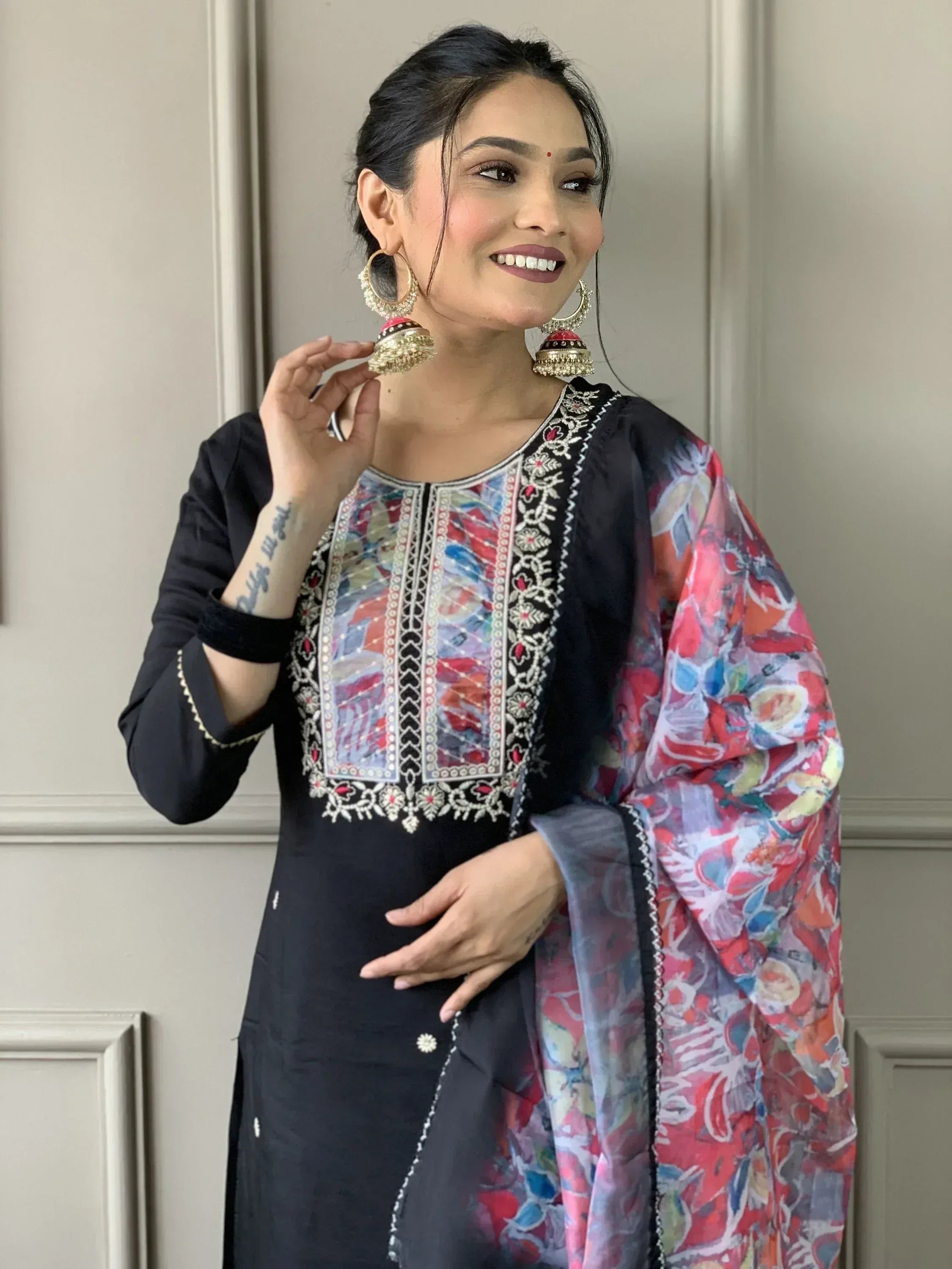 Woman in black embroidered kurta with floral dupatta and jhumka earrings, Indian ethnic wear