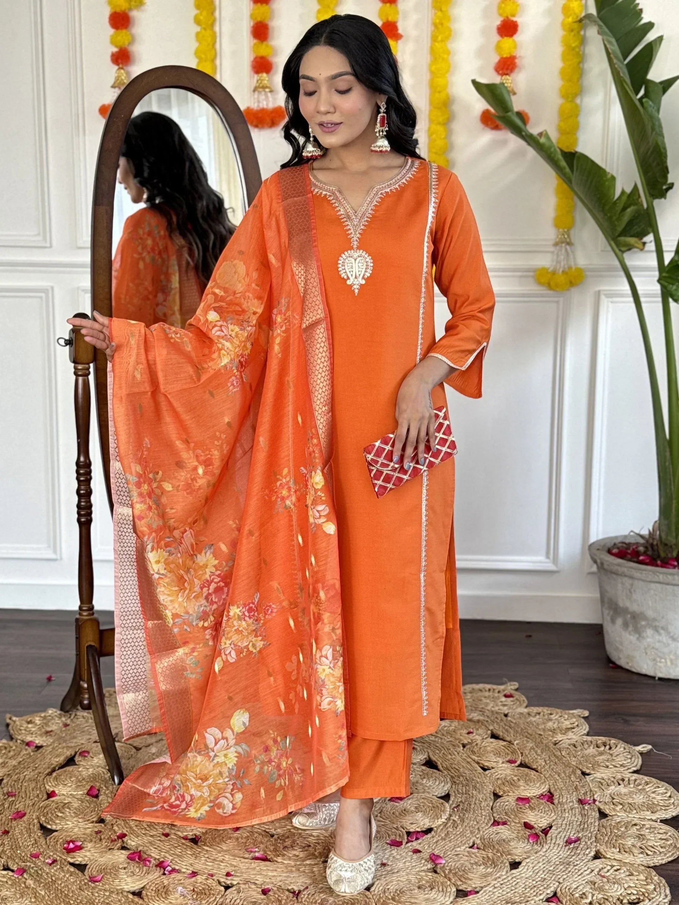 Orange embroidered salwar kameez with floral dupatta, perfect for festive occasions and ethnic events.