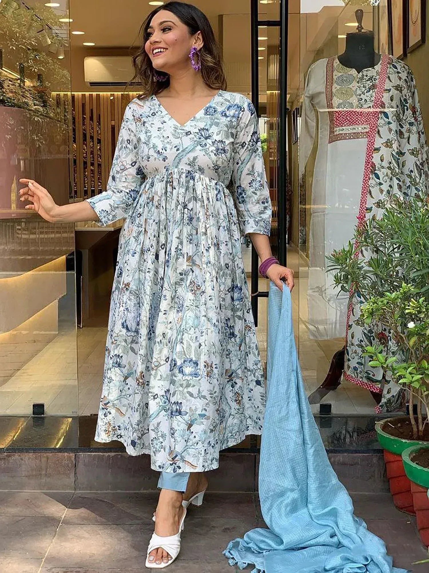 Woman in floral print ethnic gown with blue dupatta, stylish Indian wear for women
