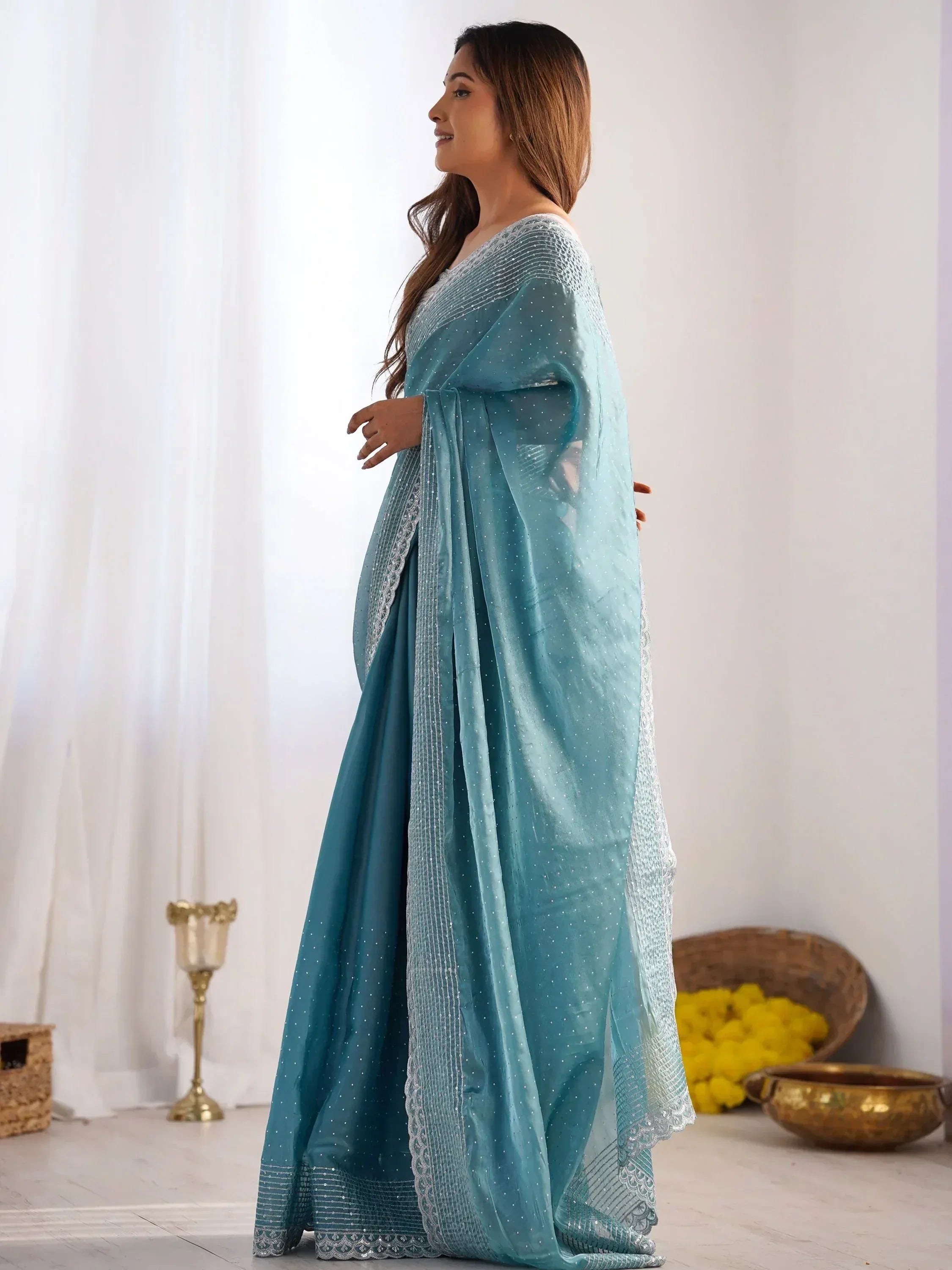 Teal blue designer saree with silver embellishments and sheer dupatta, ethnic wear for women