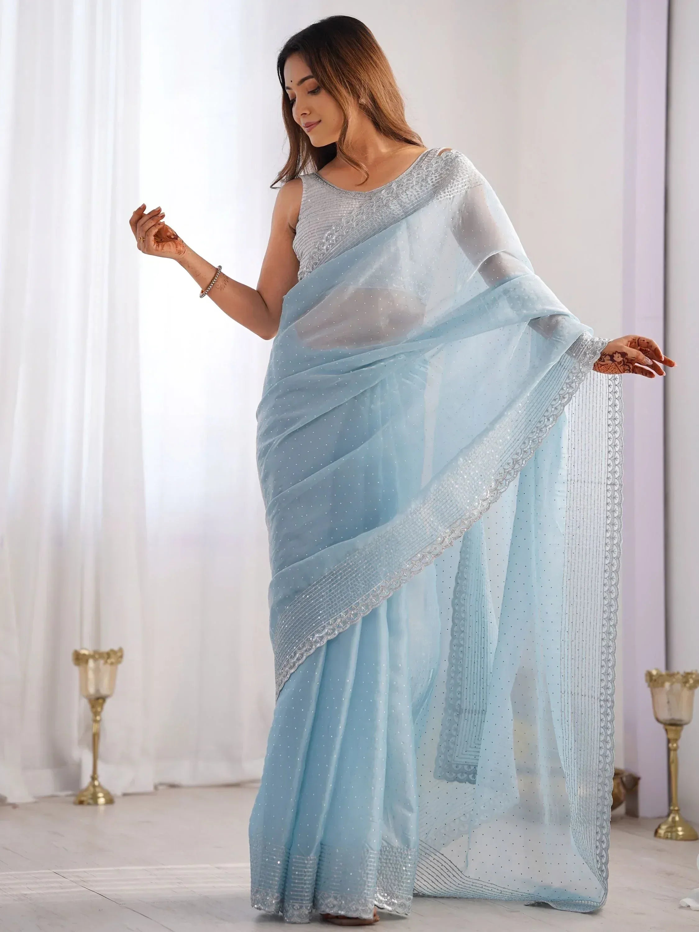 Light blue designer saree with silver embroidery and sequins, perfect for ethnic occasions