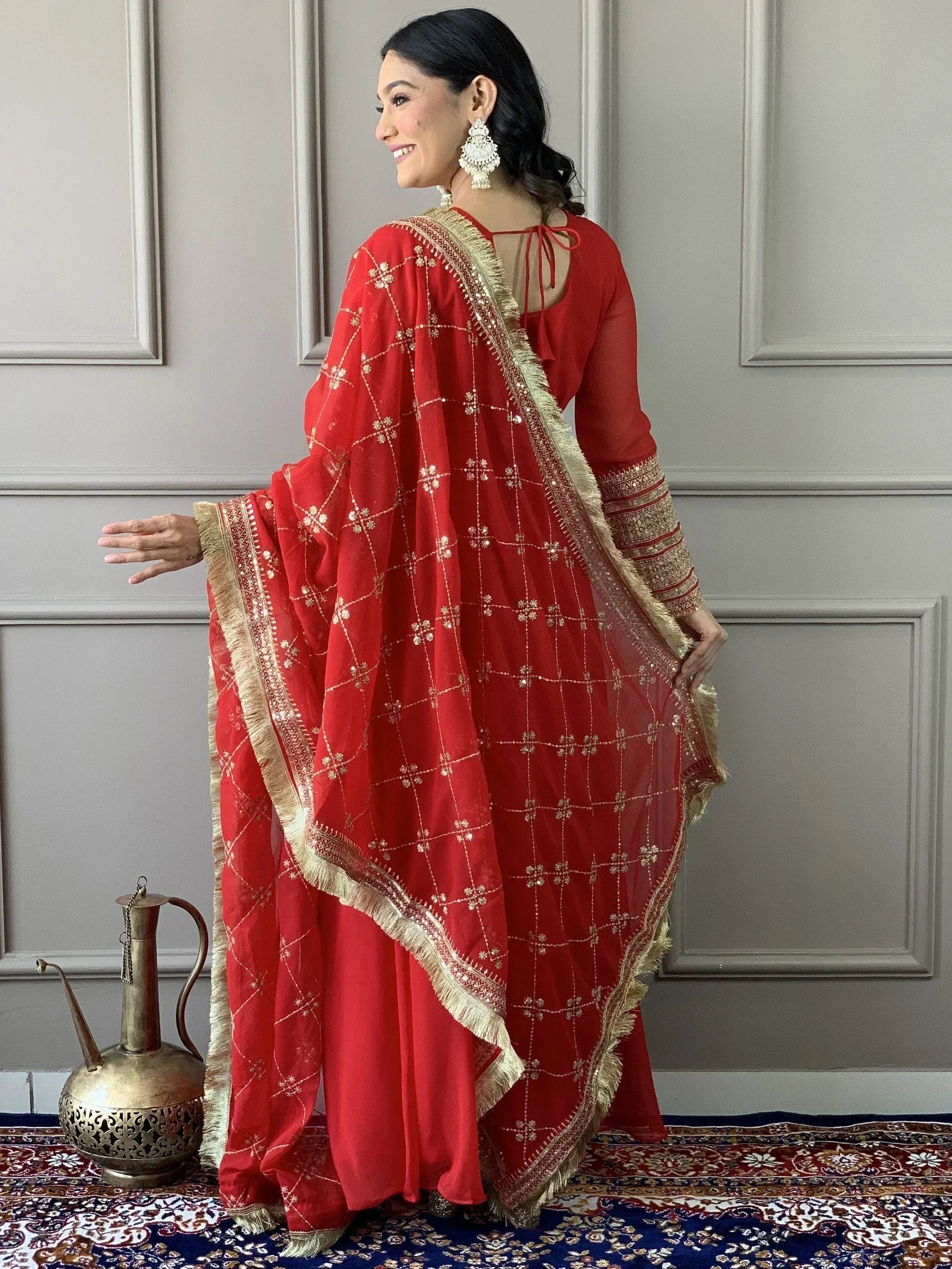 Red embroidered Indian salwar kameez with gold detailing, perfect for festive occasions and weddings.