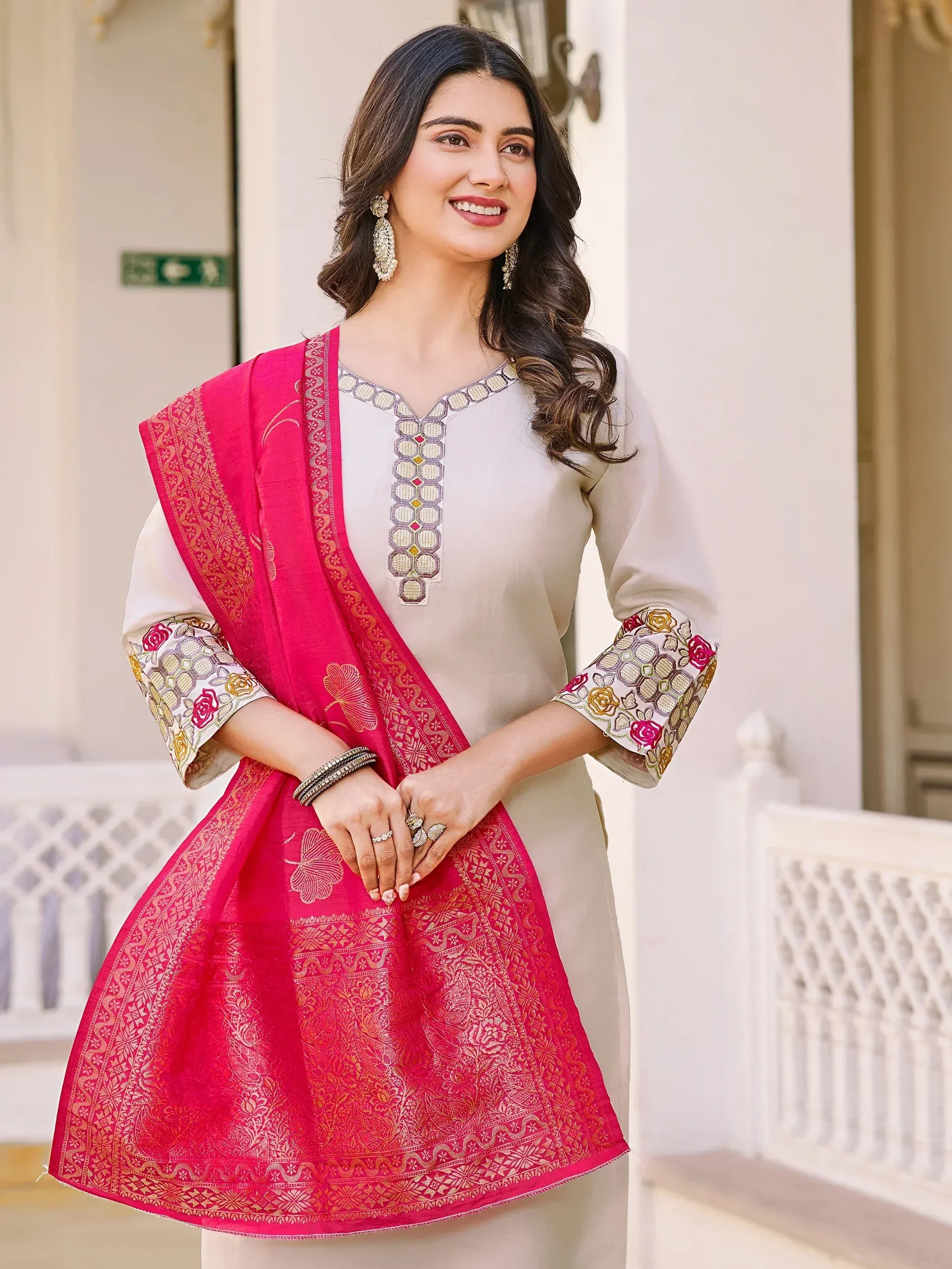 Elegant beige kurta with floral embroidery, paired with vibrant pink dupatta for Indian ethnic wear.