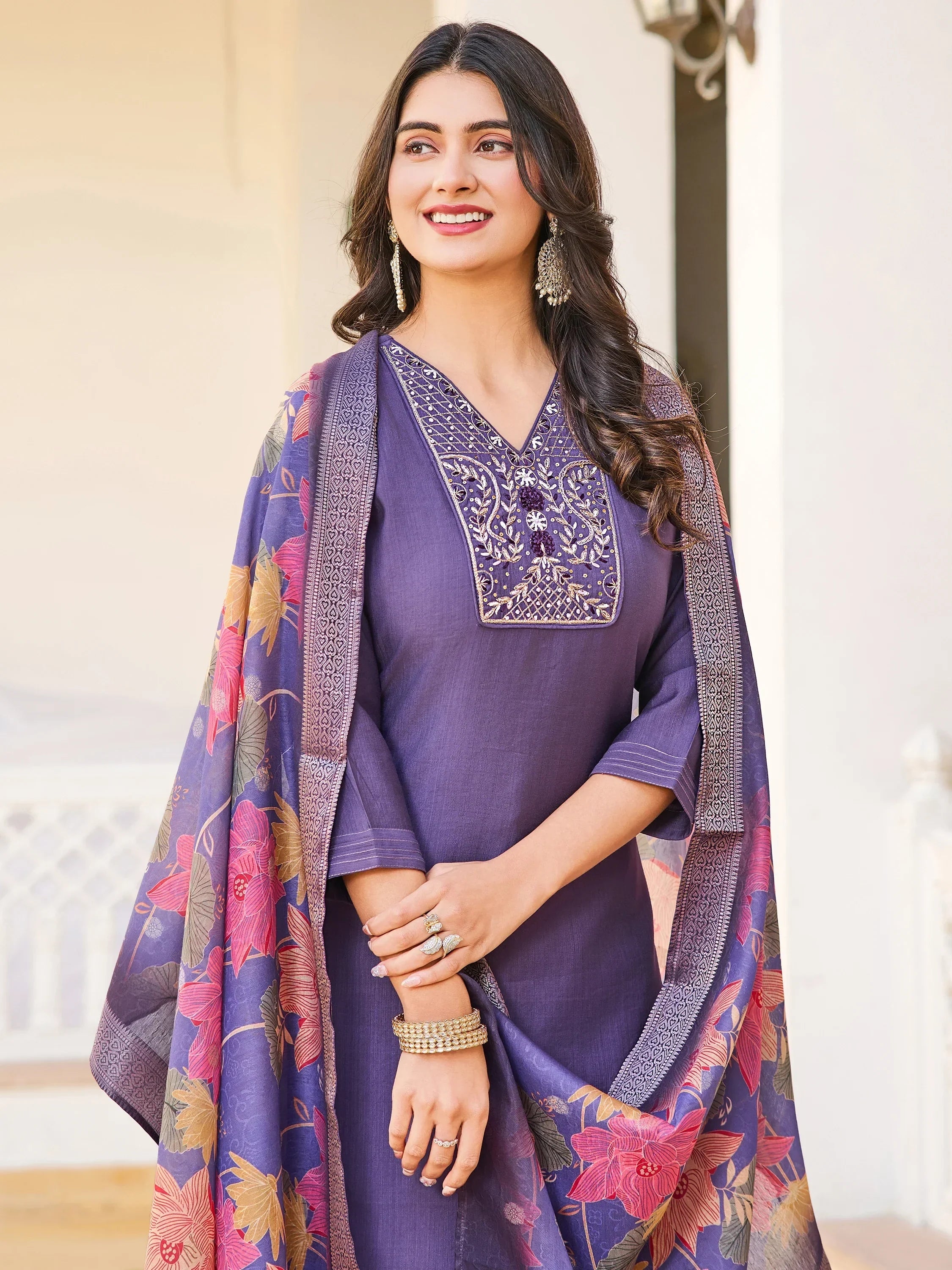 Woman in purple embroidered salwar kameez with floral dupatta, ethnic Indian wear