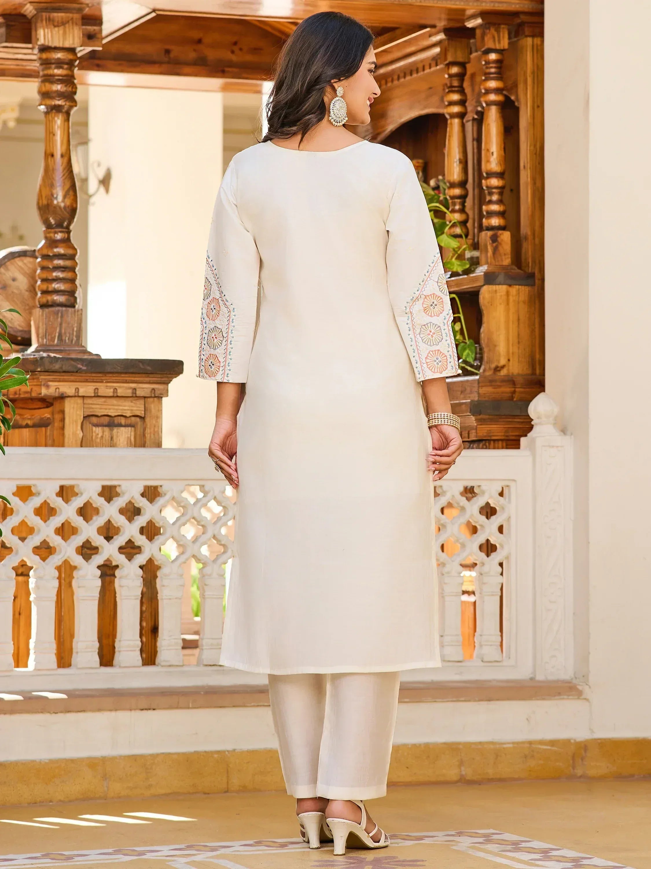 White embroidered kurta with floral sleeve design, paired with palazzo pants, ideal for Indian ethnic wear