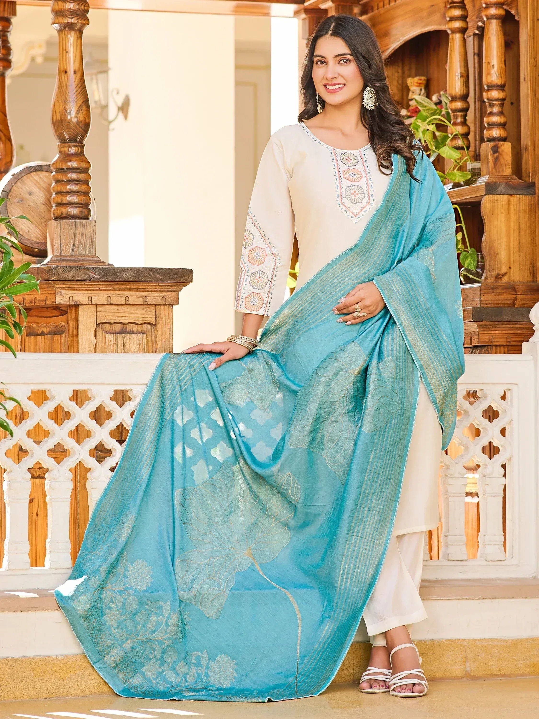 Woman in cream embroidered kurta with turquoise floral dupatta, ethnic Indian wear