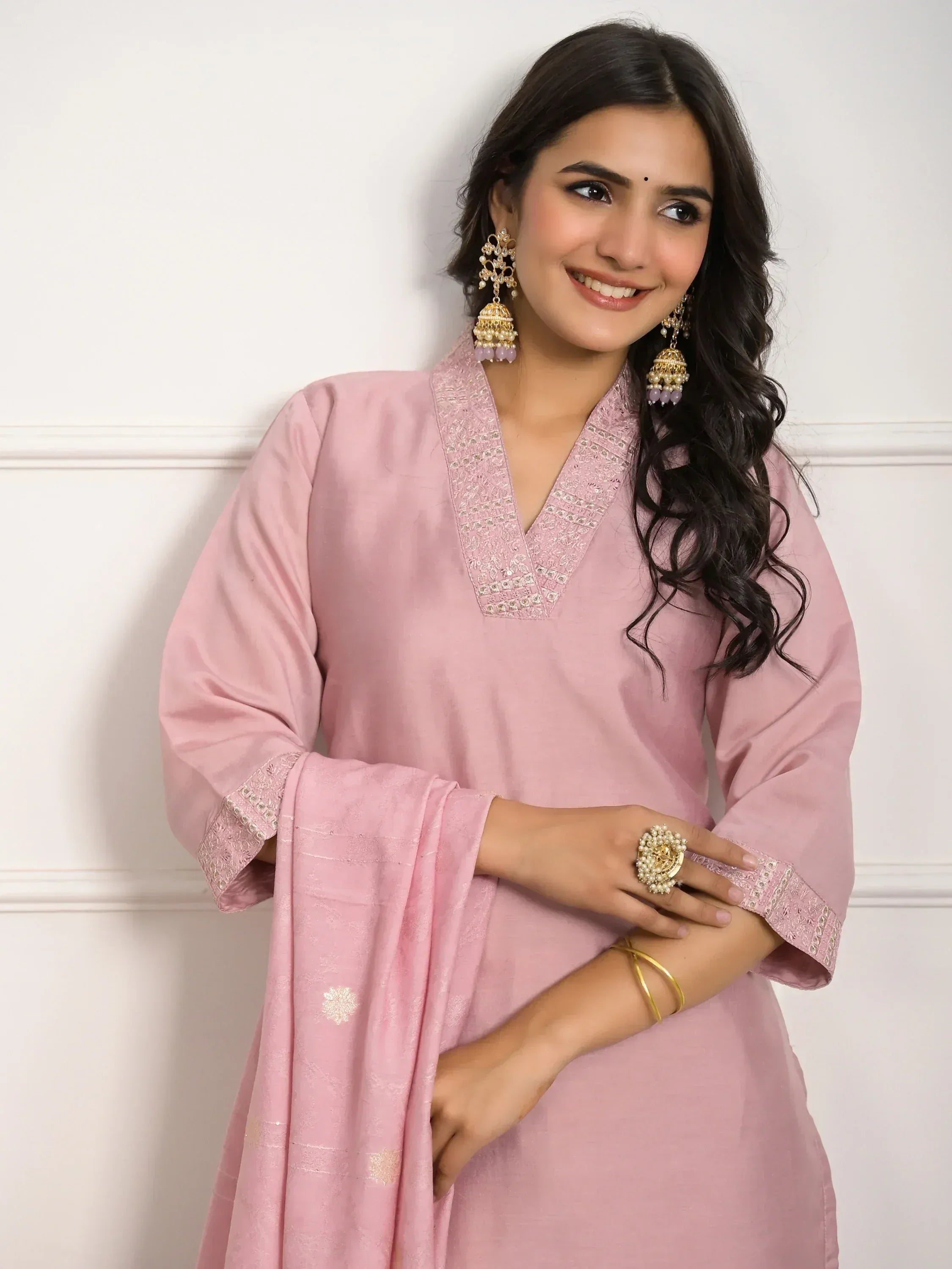 Pink embroidered ethnic kurti with matching dupatta, styled with jhumka earrings and pearl ring for Indian wear