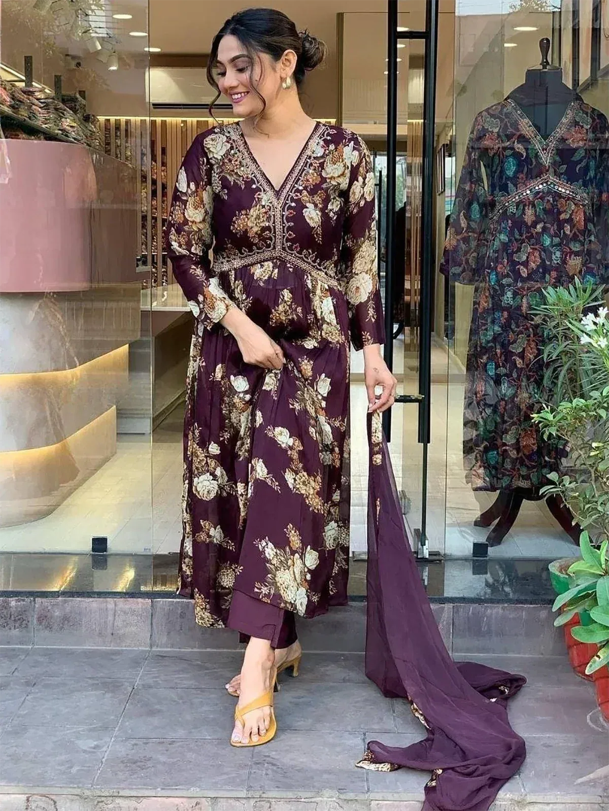 Woman in maroon floral printed ethnic gown with matching dupatta, stylish Indian wear for festive occasions