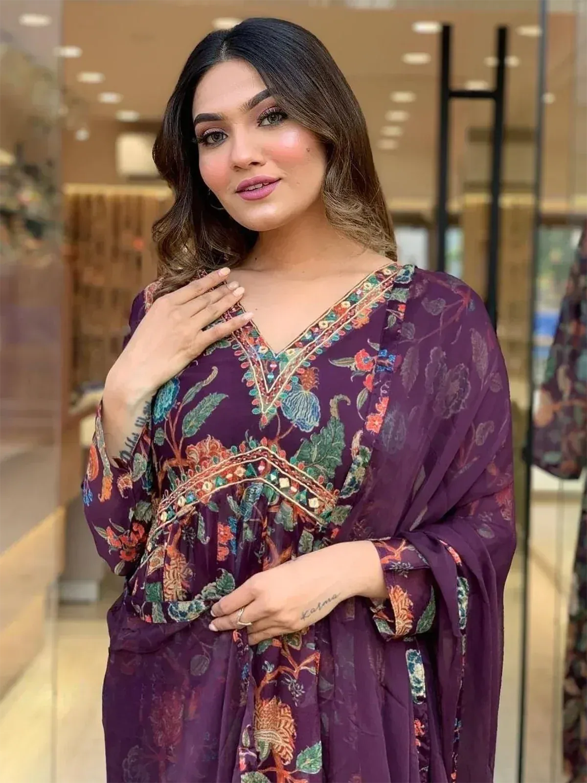 Purple floral ethnic gown with embroidered neckline, perfect for Indian occasions and festive wear.