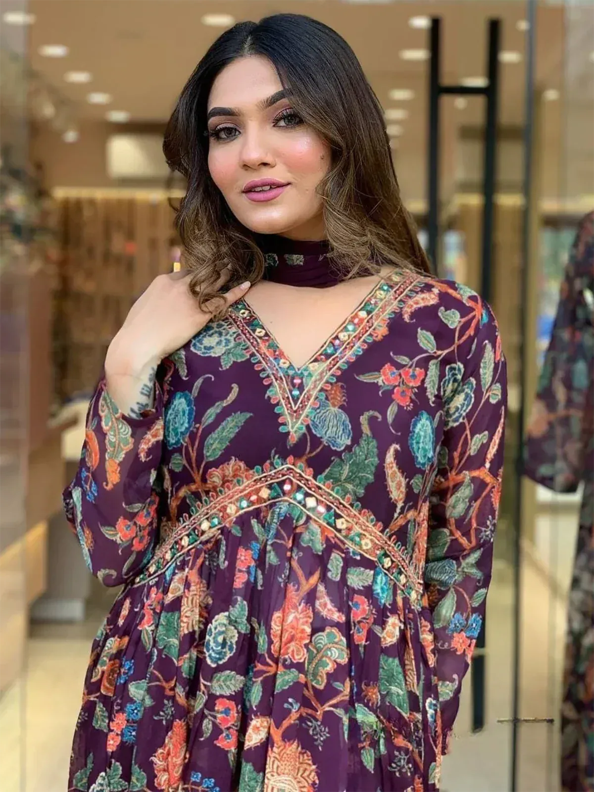 Purple floral ethnic gown with V-neck and mirror work, perfect for Indian occasions