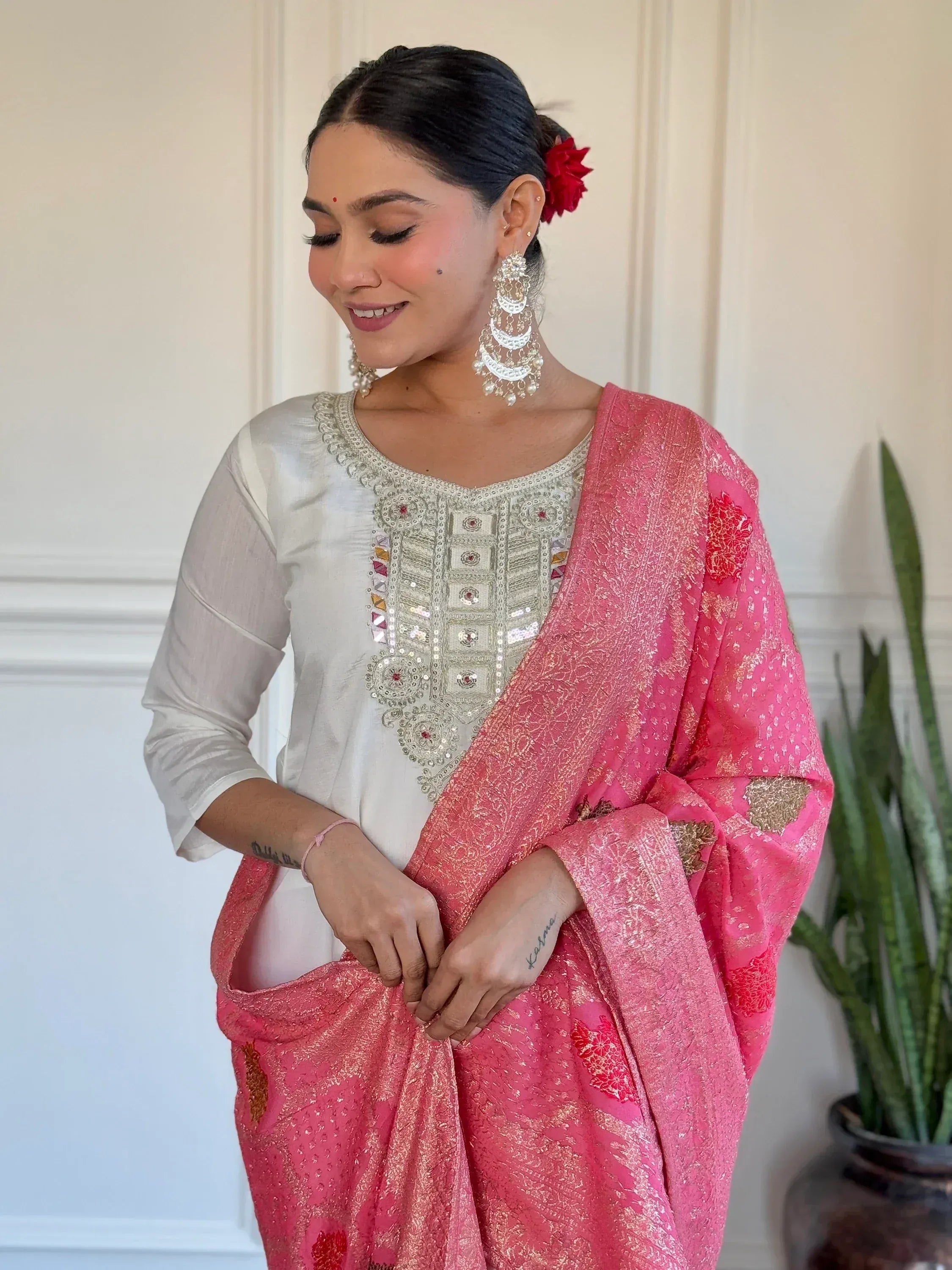 Woman in white embroidered kurta with pink floral dupatta, traditional Indian ethnic wear
