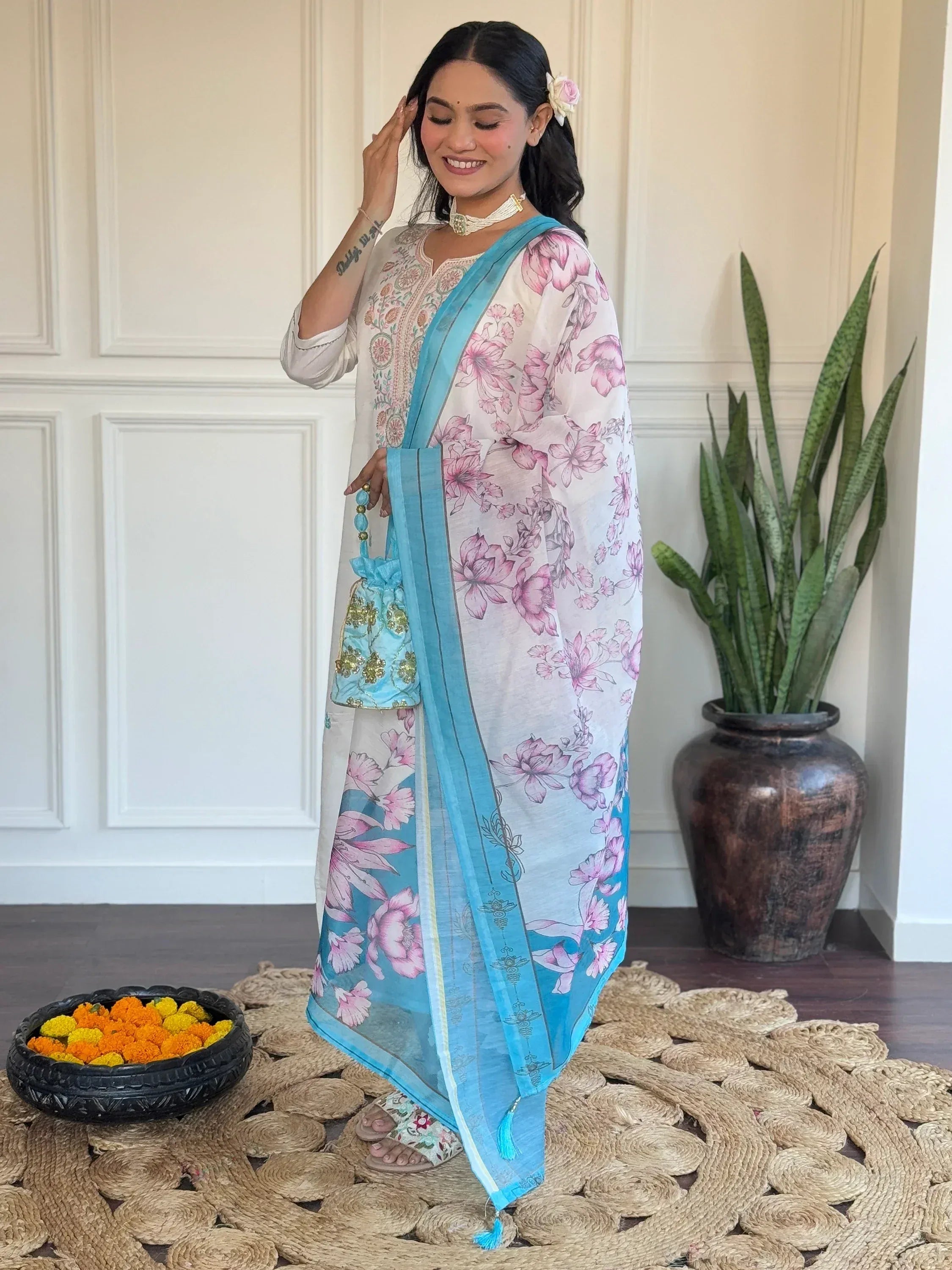 Woman in floral print salwar kameez with blue dupatta, ethnic Indian wear for festive occasions