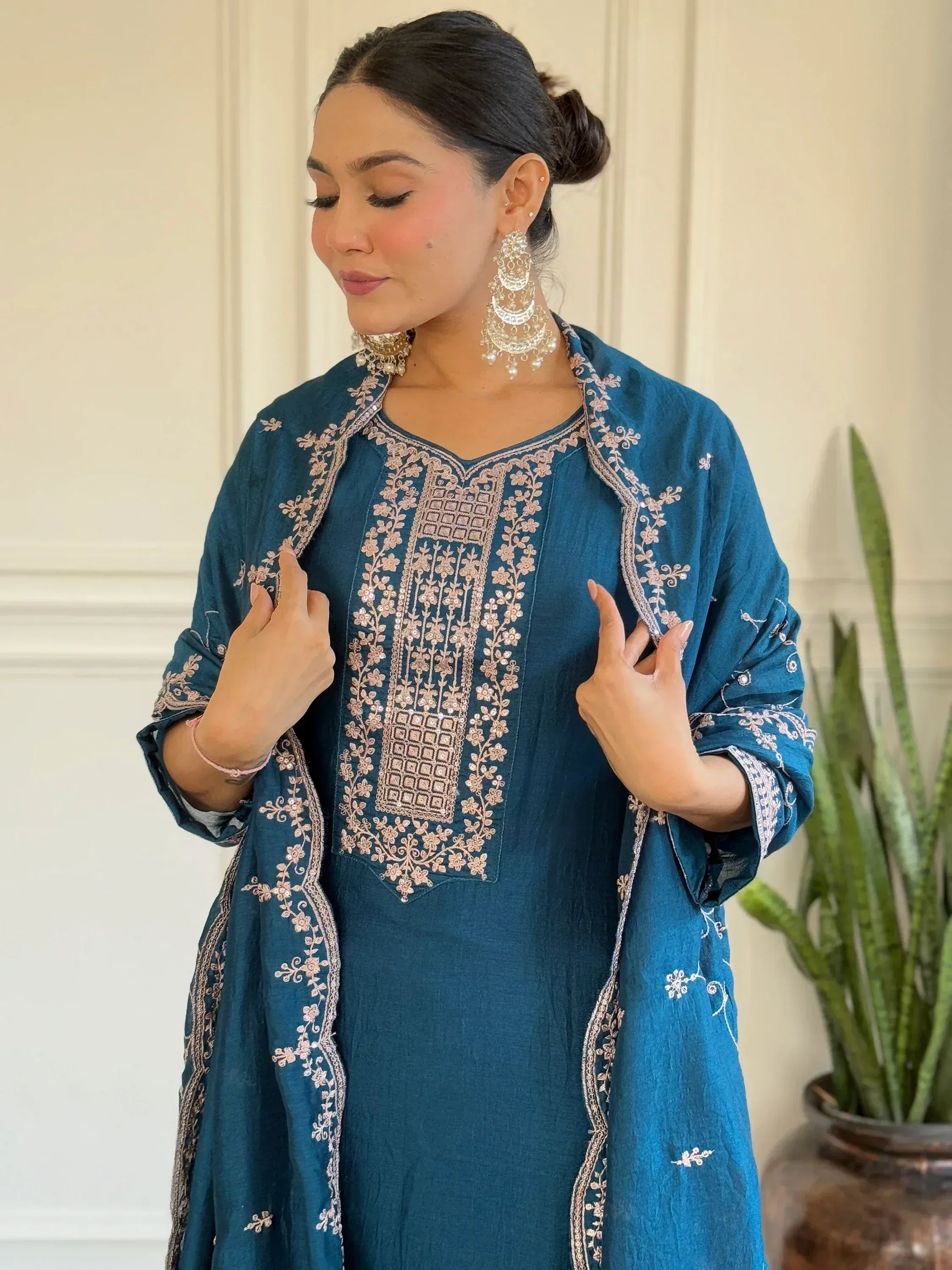 Teal embroidered kurta with floral detailing, paired with matching dupatta and statement earrings for ethnic wear.