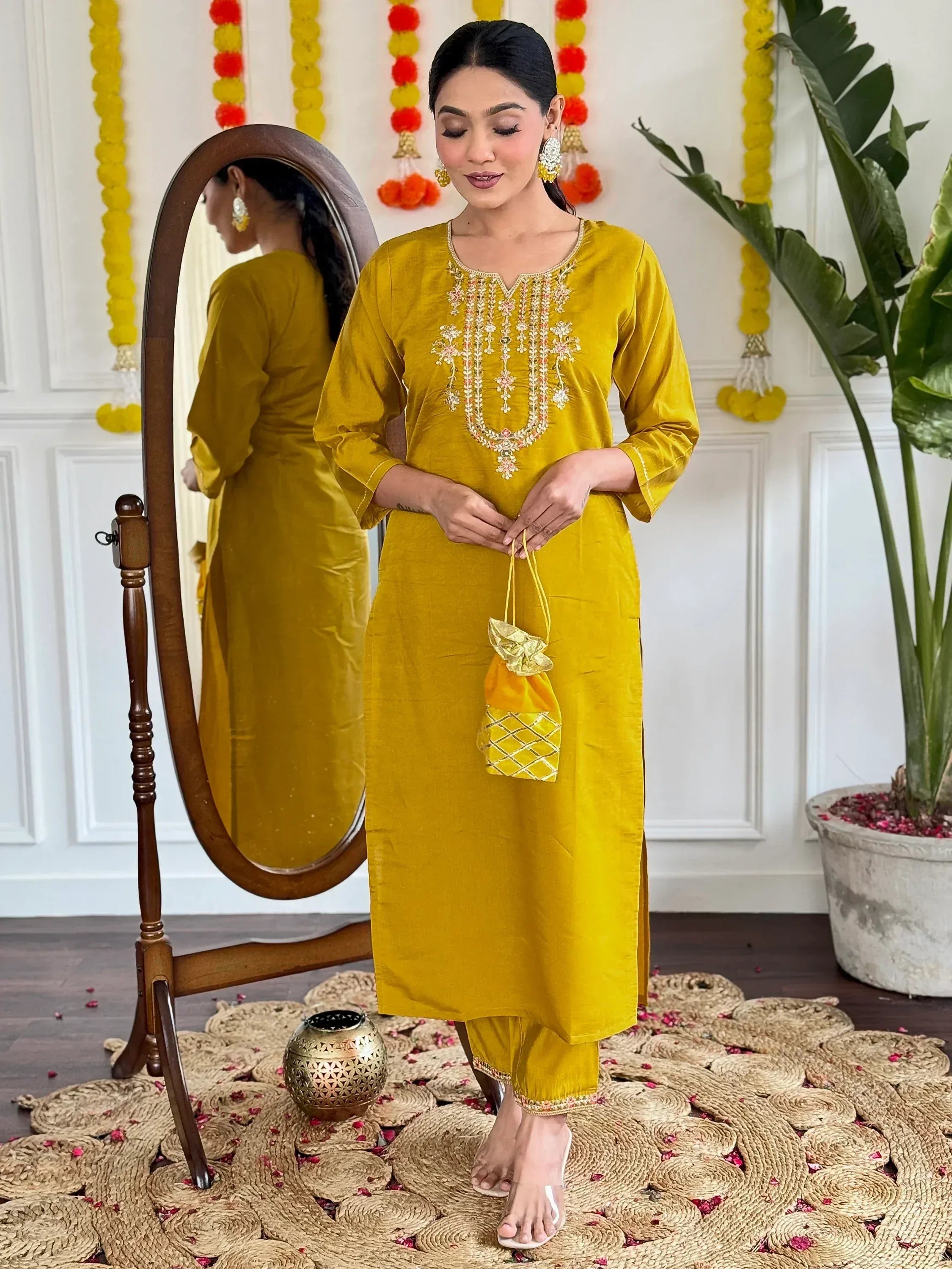Yellow embroidered kurta set with matching potli bag, perfect for Indian ethnic occasions