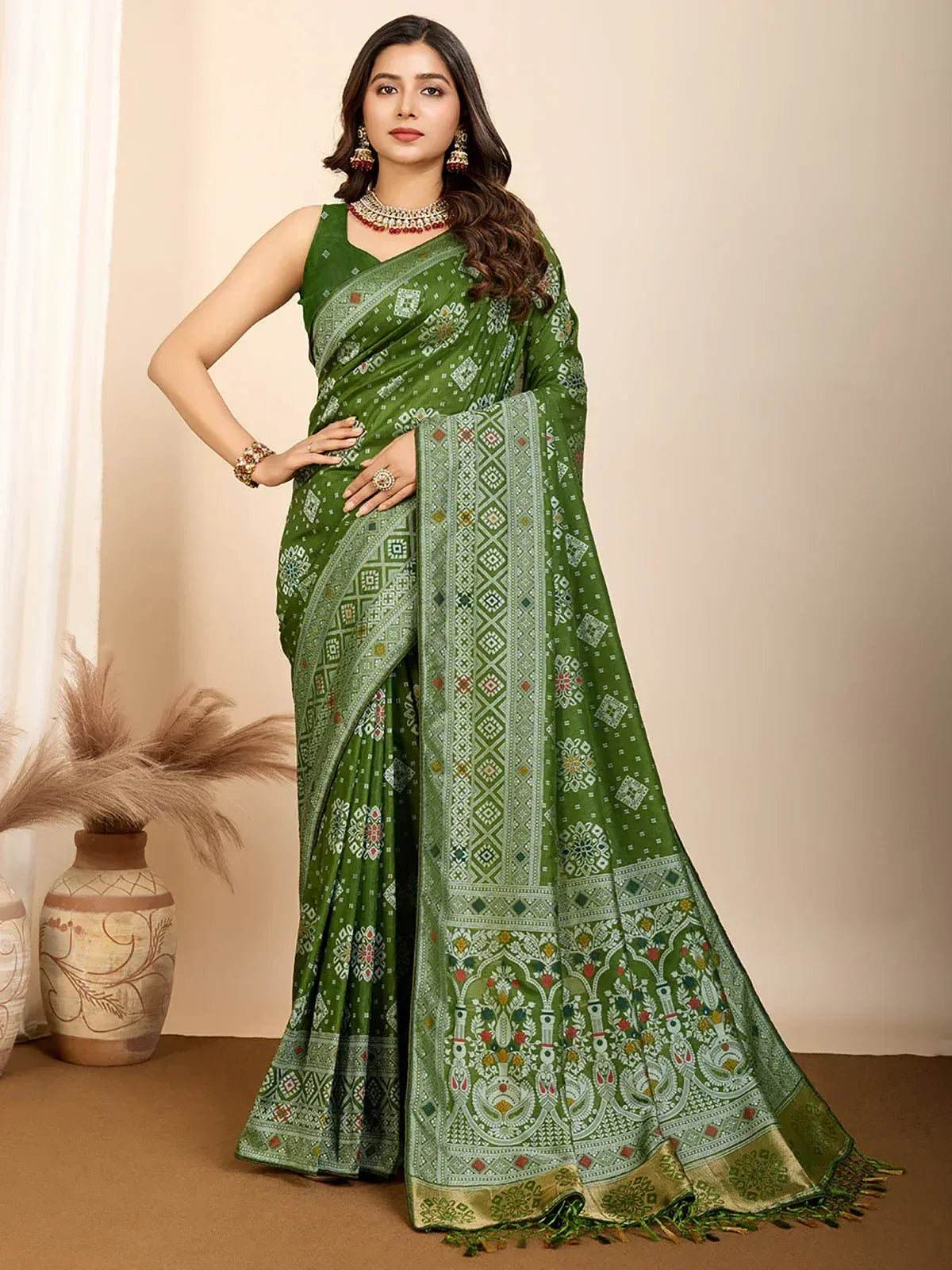 Green printed saree with ethnic motifs and border, styled with jewelry for traditional occasions