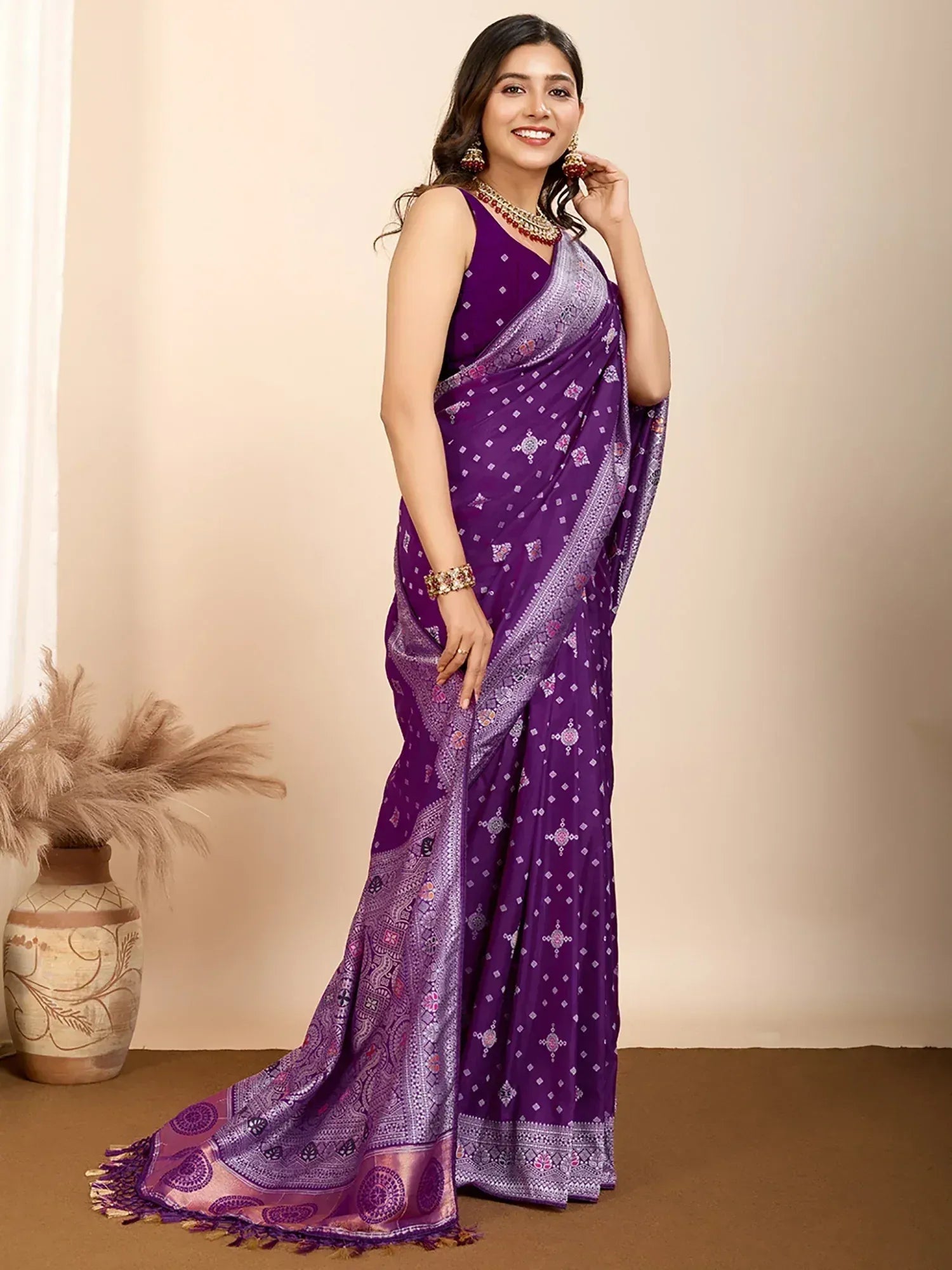 Purple printed saree with intricate border and blouse, styled with traditional jewelry for ethnic wear