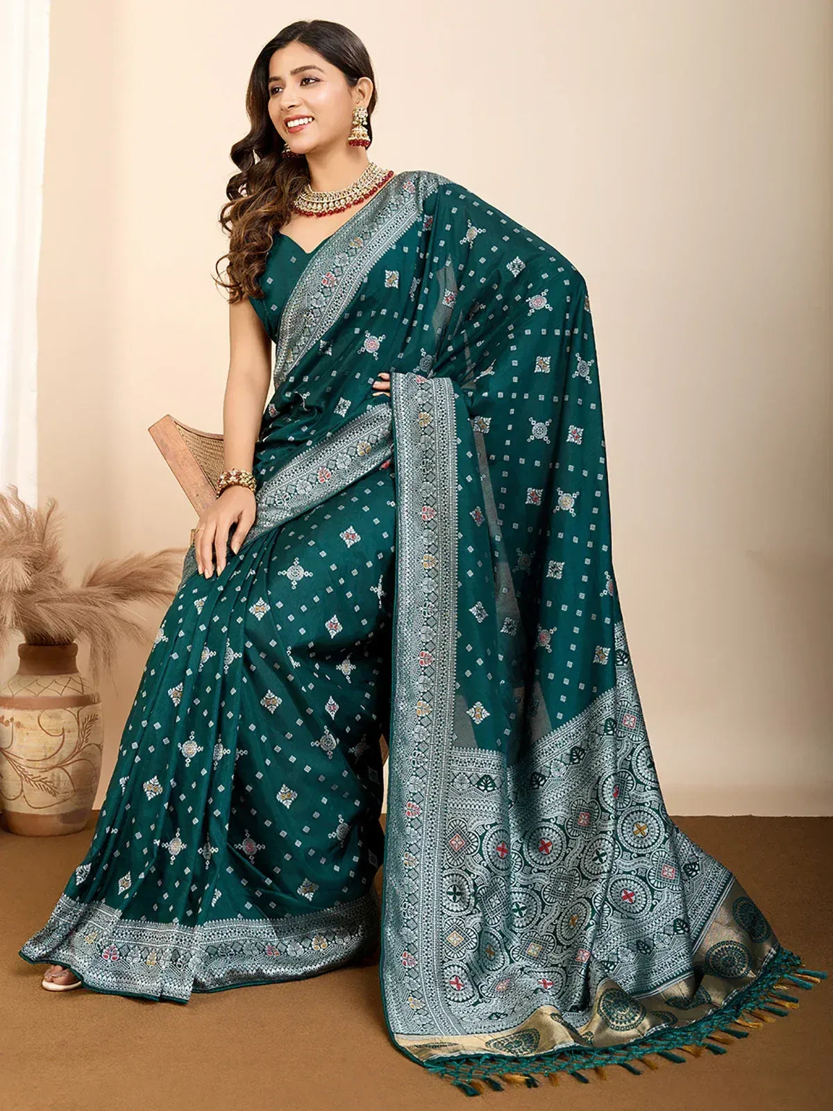 Emerald green printed saree with intricate silver border and tassels, styled with traditional jewelry for ethnic wear.