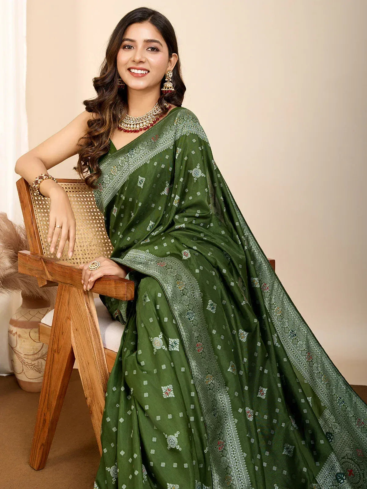 Green printed saree with intricate border, styled with traditional jewelry for ethnic wear
