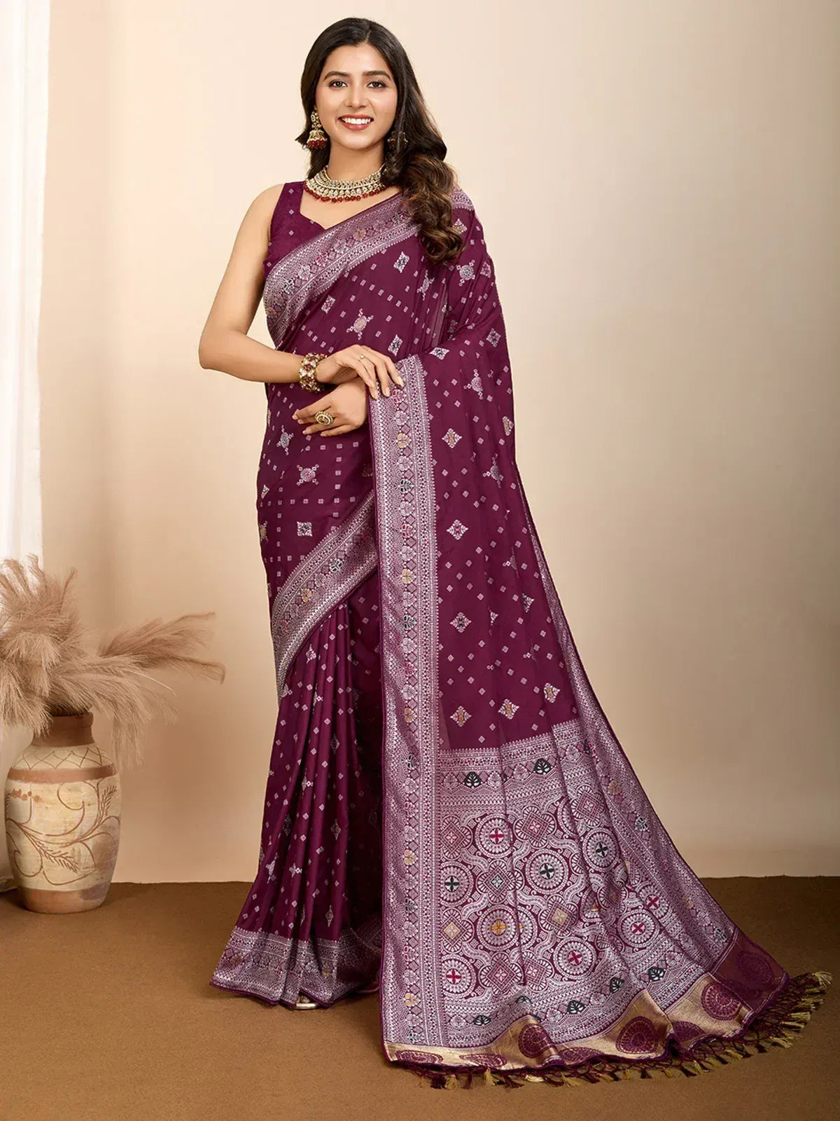 Purple printed saree with intricate border, styled with ethnic jewelry for traditional occasions