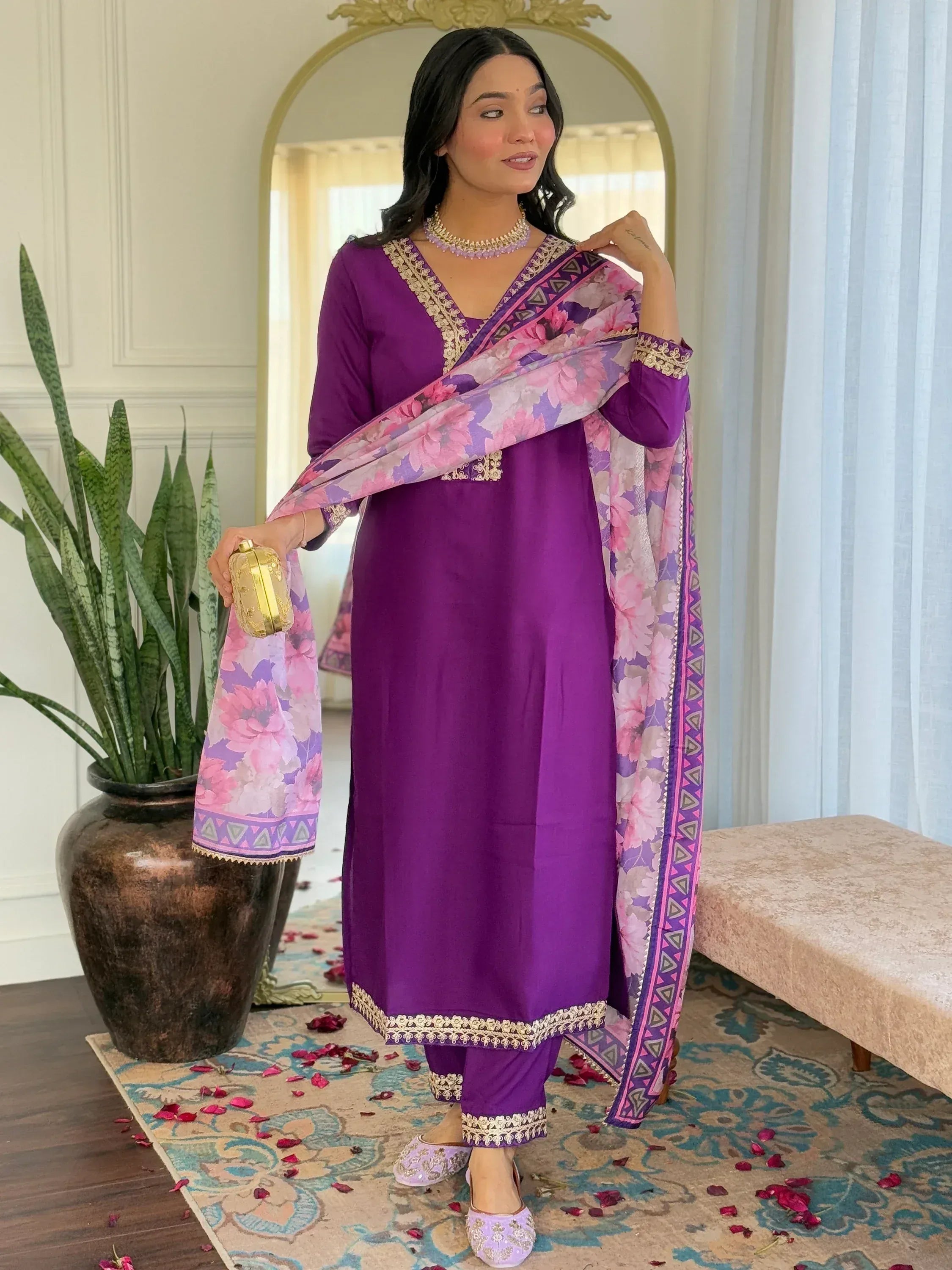 Purple ethnic salwar kameez with floral dupatta and gold embroidery, perfect for festive occasions.