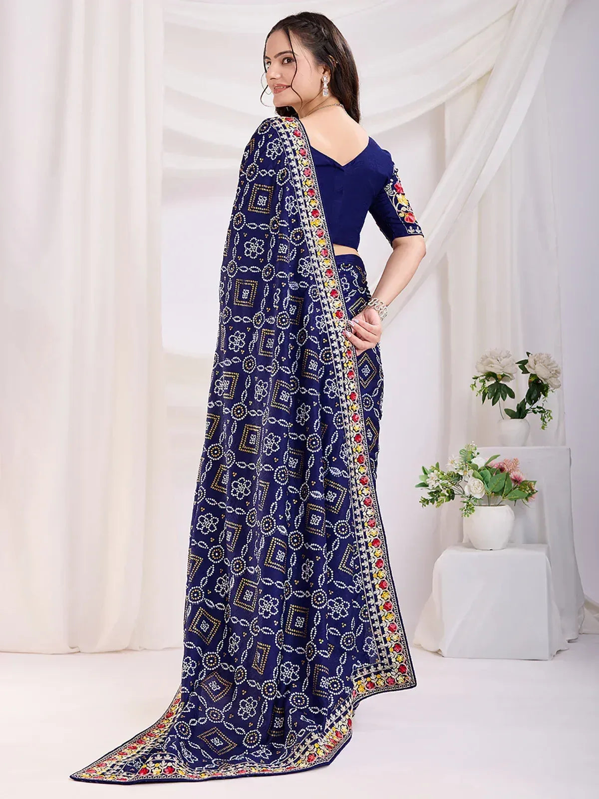 Navy blue printed saree with floral border, paired with matching blouse, ideal for Indian ethnic occasions