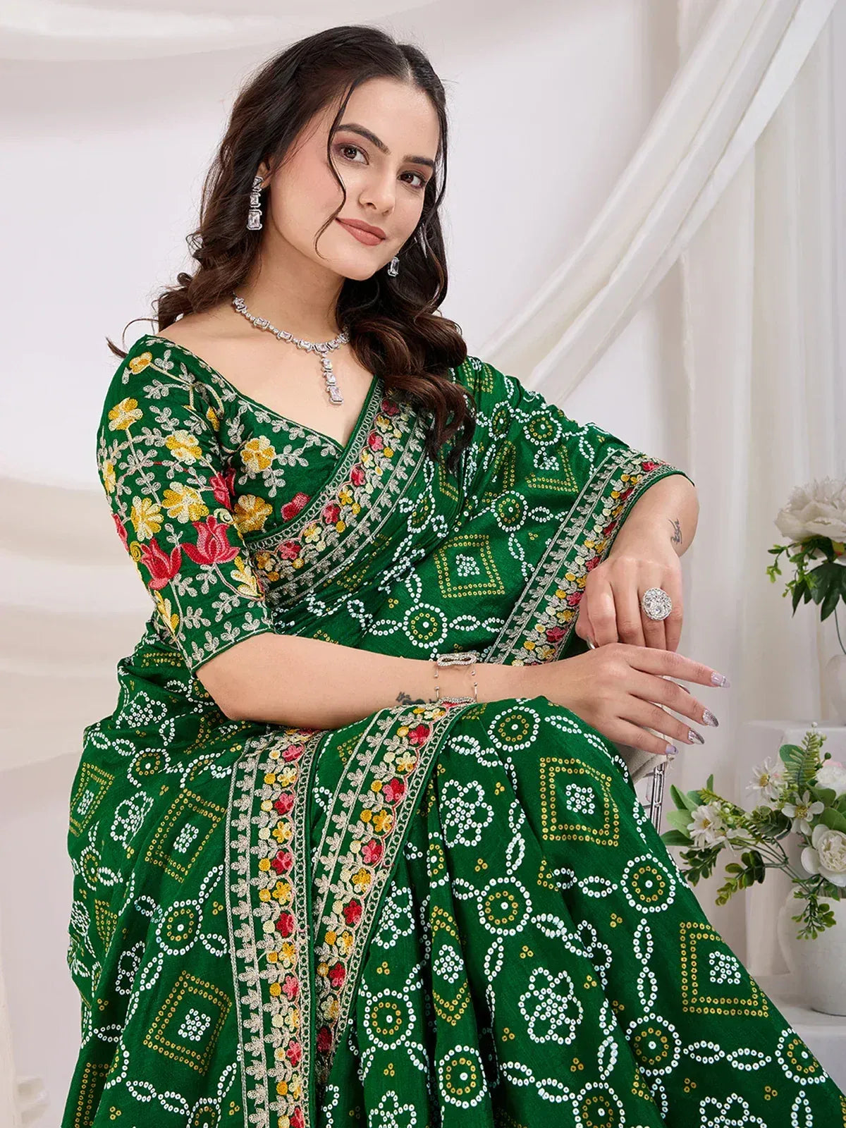 Green embroidered saree with floral and geometric patterns, perfect for Indian ethnic wear occasions.