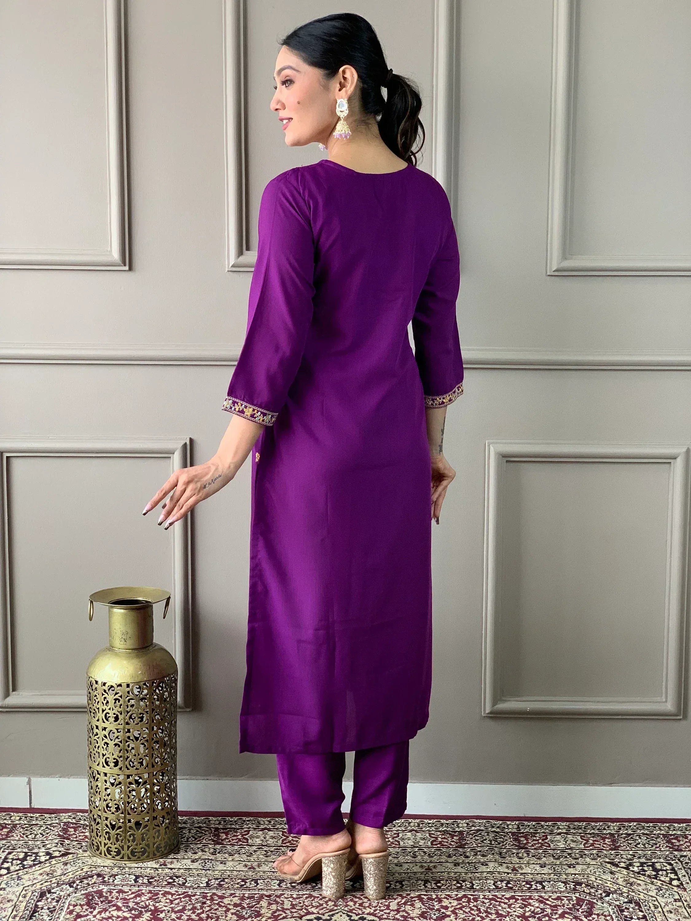 Purple ethnic kurta with embroidered sleeves and matching pants, styled with statement earrings and heels