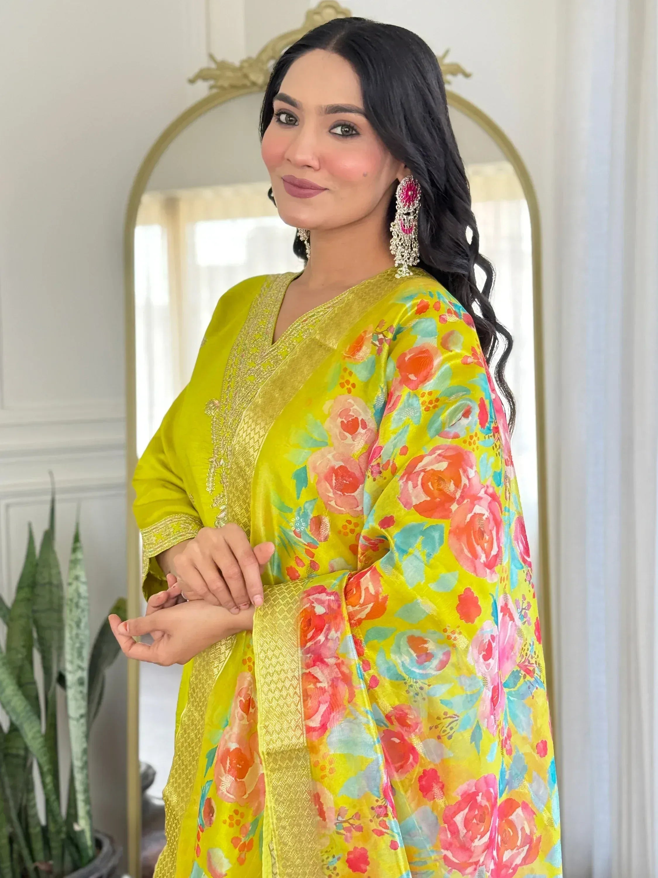 Vibrant yellow floral Indian ethnic gown with gold trim, perfect for festive occasions and celebrations.