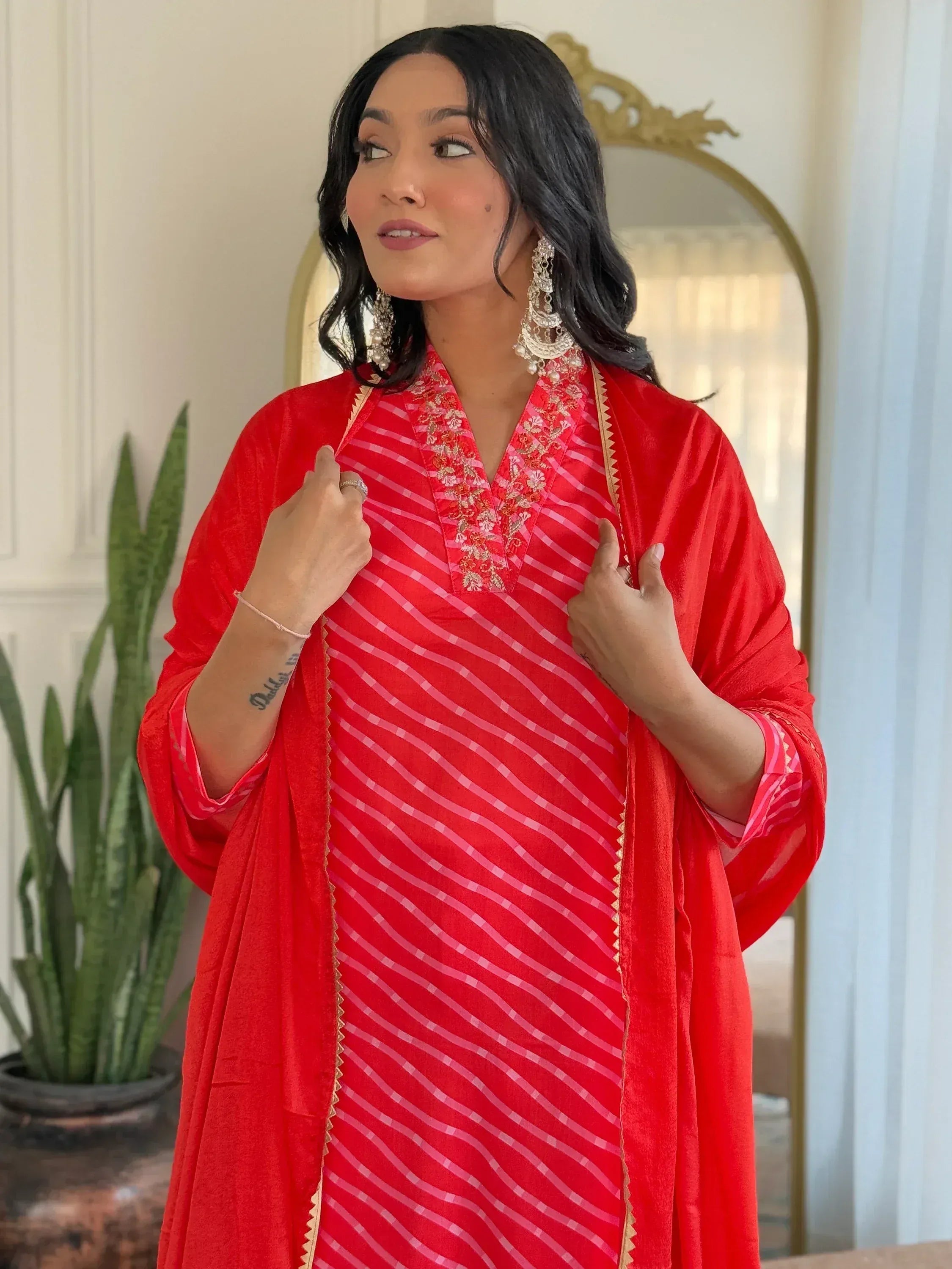 Red striped ethnic kurta with embroidered neckline and matching dupatta, styled with jhumka earrings