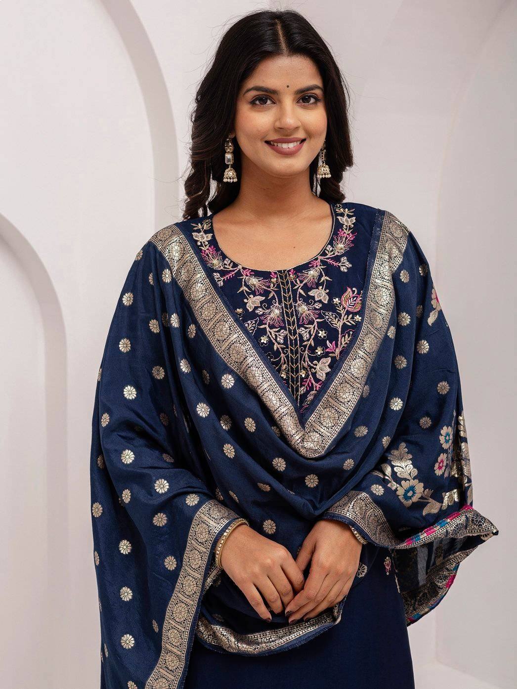 Navy blue embroidered ethnic kurta with floral motifs and gold trim, paired with matching dupatta for festive occasions