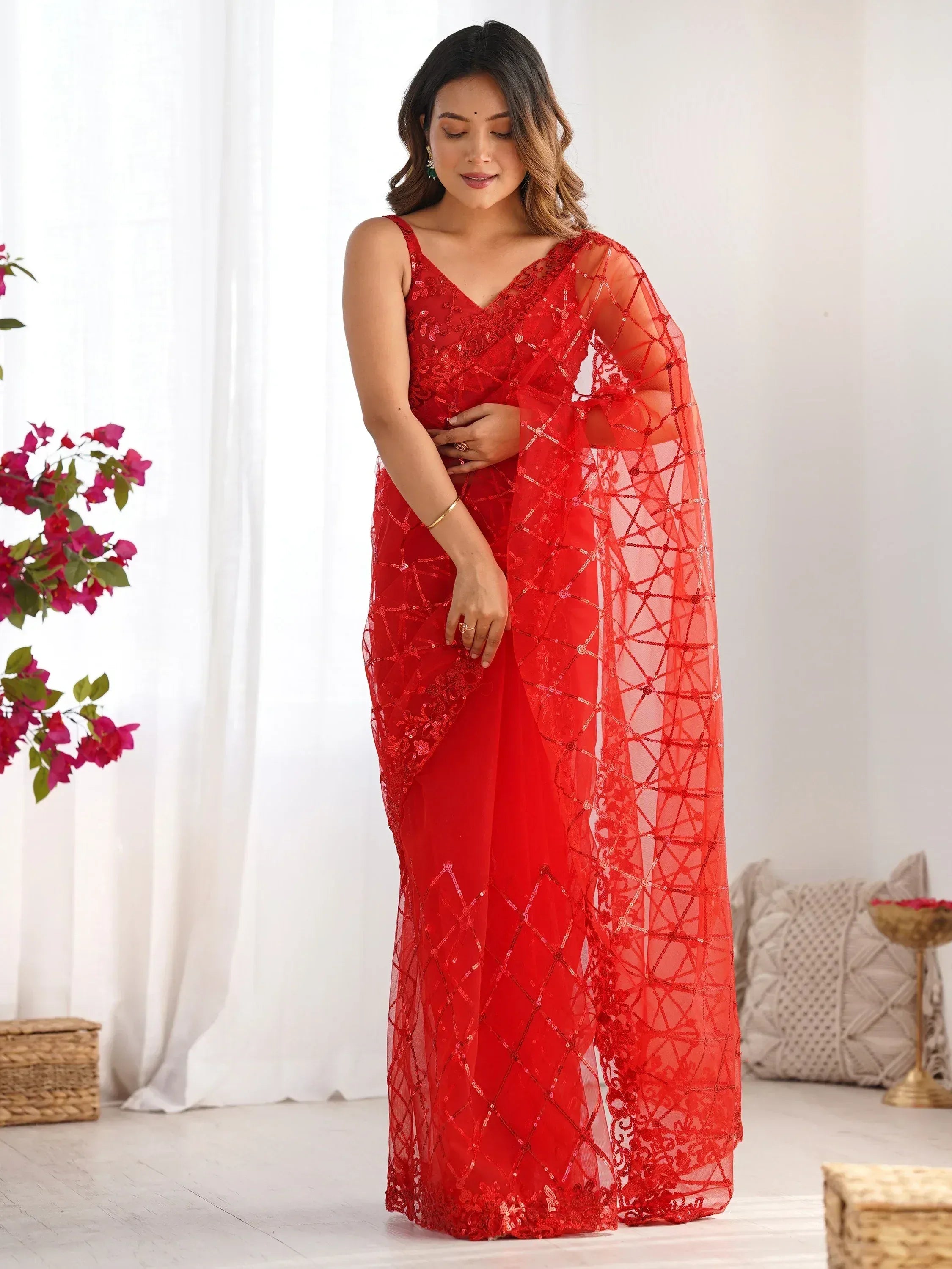 Red sequin-embellished ethnic saree with sheer overlay, perfect for Indian weddings and festive occasions