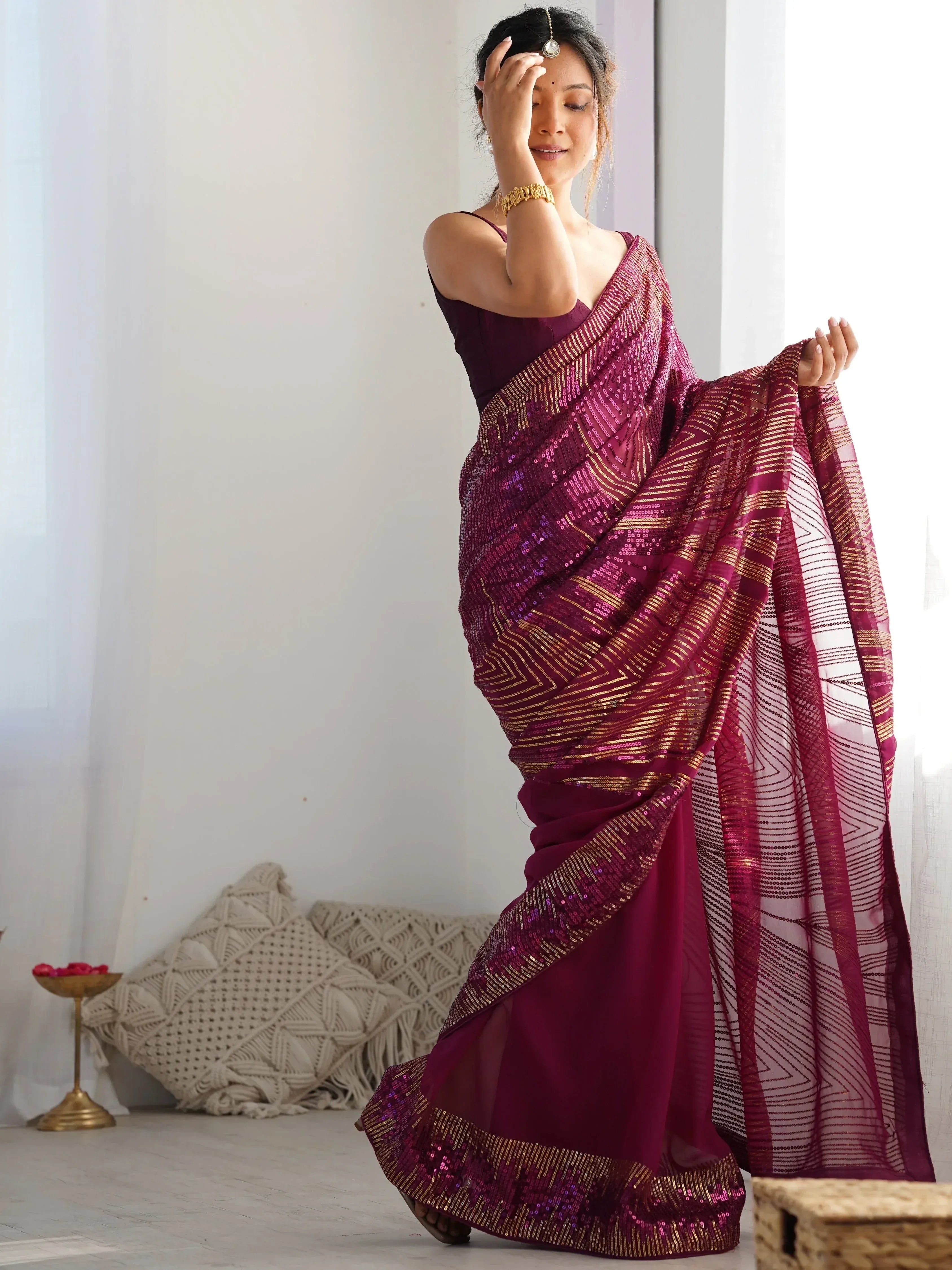 Woman in maroon sequin saree with gold stripes, Indian ethnic wear, stylish designer saree
