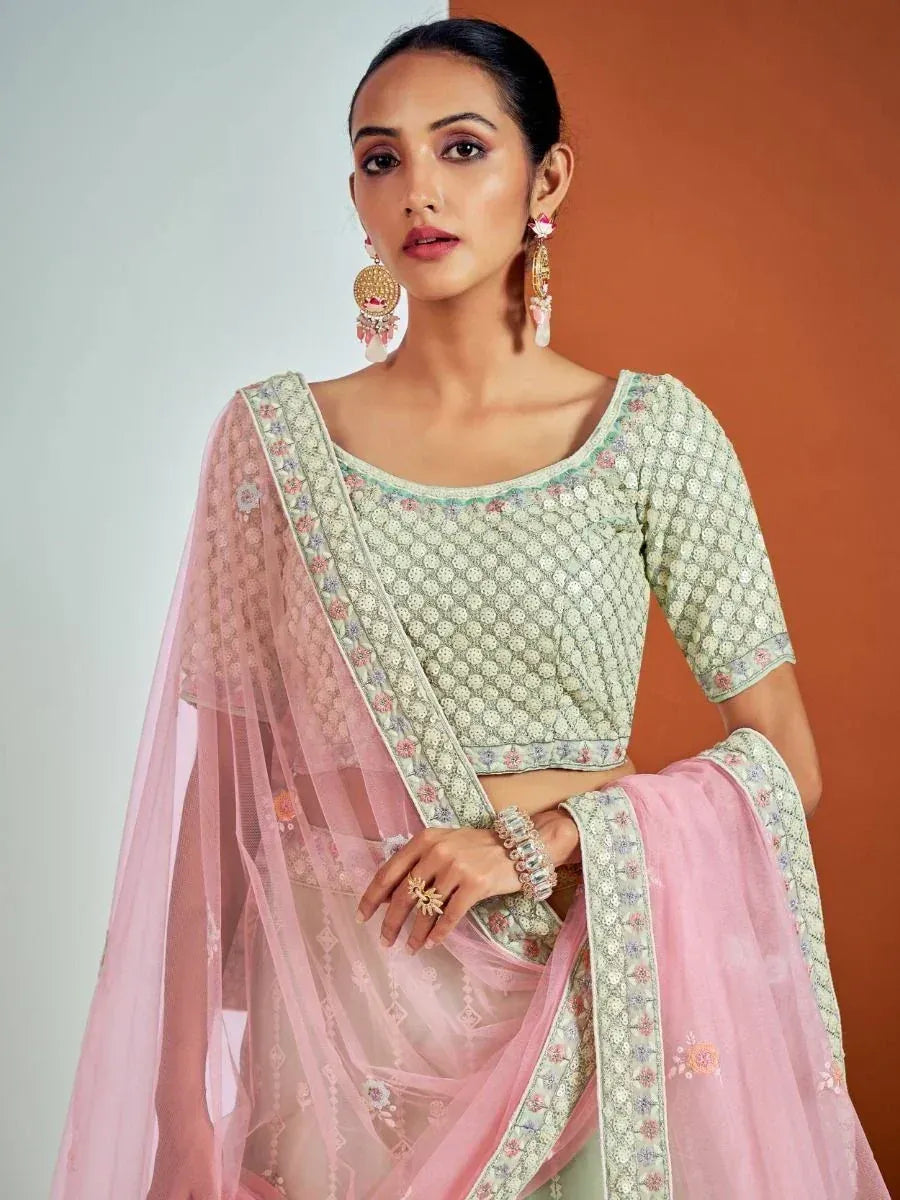 Elegant pastel green and pink embroidered lehenga choli with sheer dupatta, perfect for Indian ethnic occasions