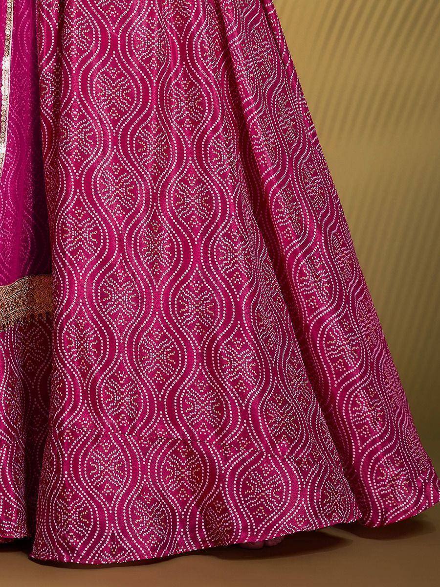 Fuchsia ethnic lehenga with intricate white dot patterns and gold border detailing