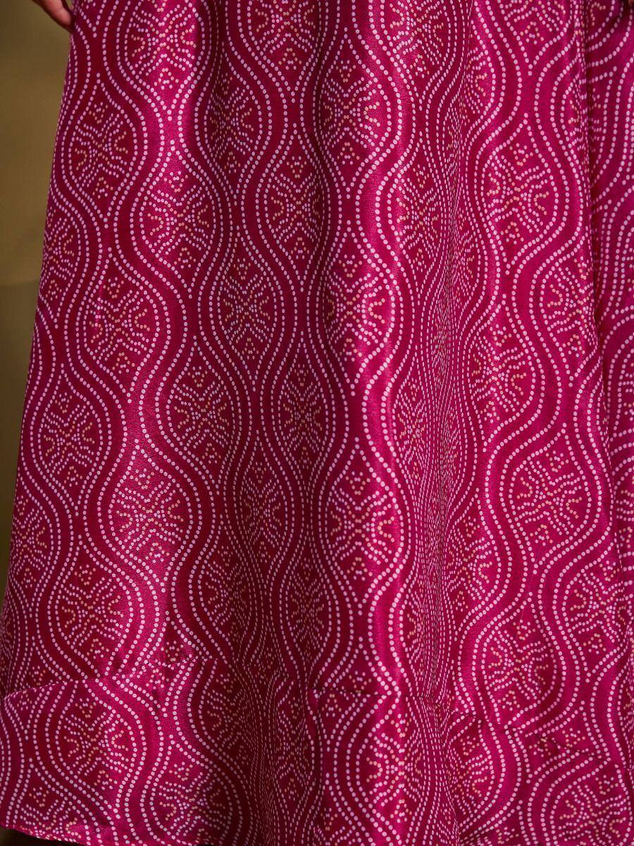 Fuchsia ethnic gown with white dotted wave pattern, ideal for Indian festive wear