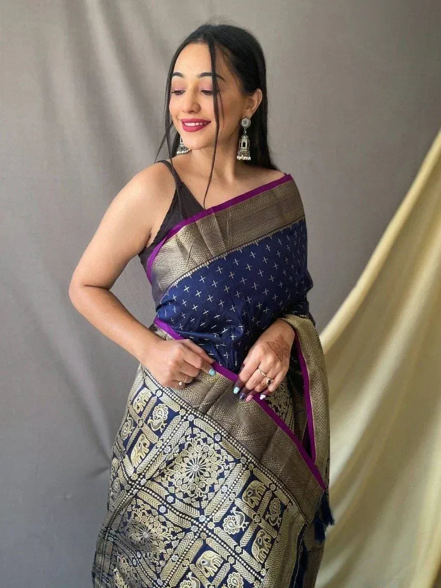 Woman in navy blue and gold ethnic saree with elephant print, perfect for Indian occasions