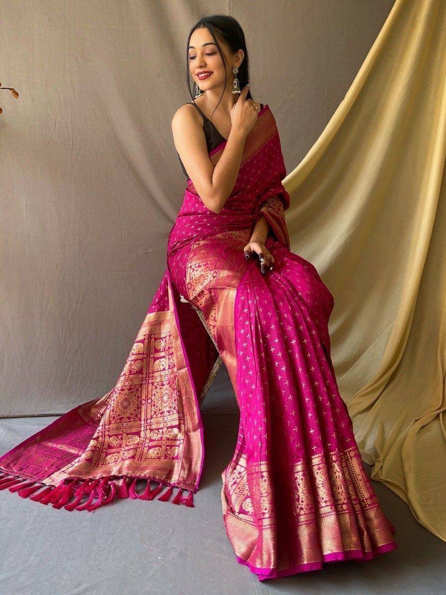 Vibrant pink designer saree with gold zari work and tassels, styled with black blouse for ethnic wear