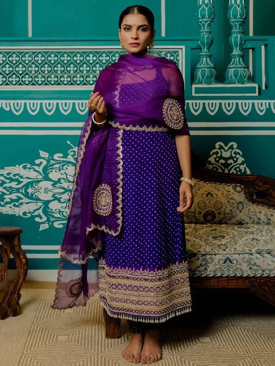 Purple ethnic salwar kameez with gold embroidery and polka dots, paired with matching dupatta for festive occasions