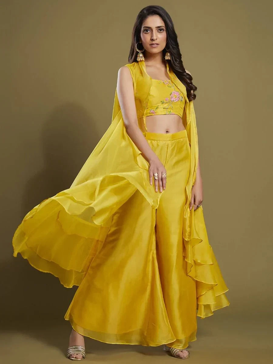 Woman wearing stylish yellow crop top and palazzo set with ruffle dupatta, ethnic wear