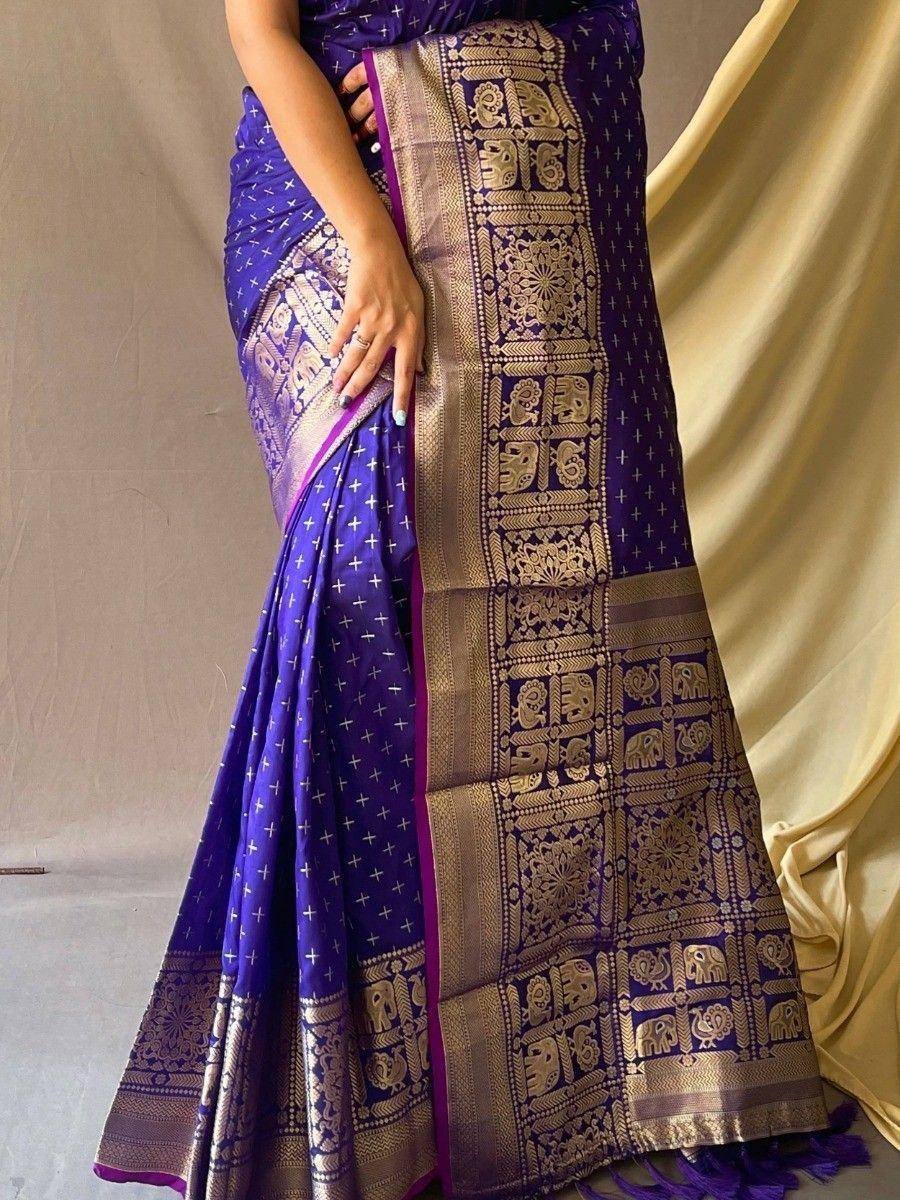 Purple Indian saree with gold elephant motifs and temple border, elegant ethnic wear for women