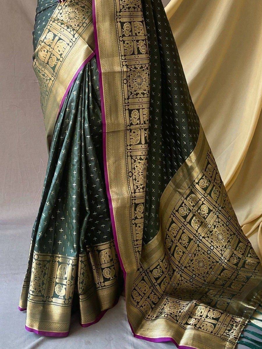 Dark green silk saree with gold elephant motifs and purple border, traditional Indian ethnic wear