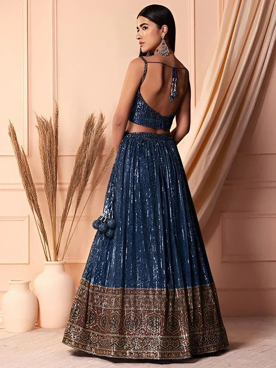 Blue sequin lehenga choli with open back and embroidered border, perfect for Indian ethnic occasions